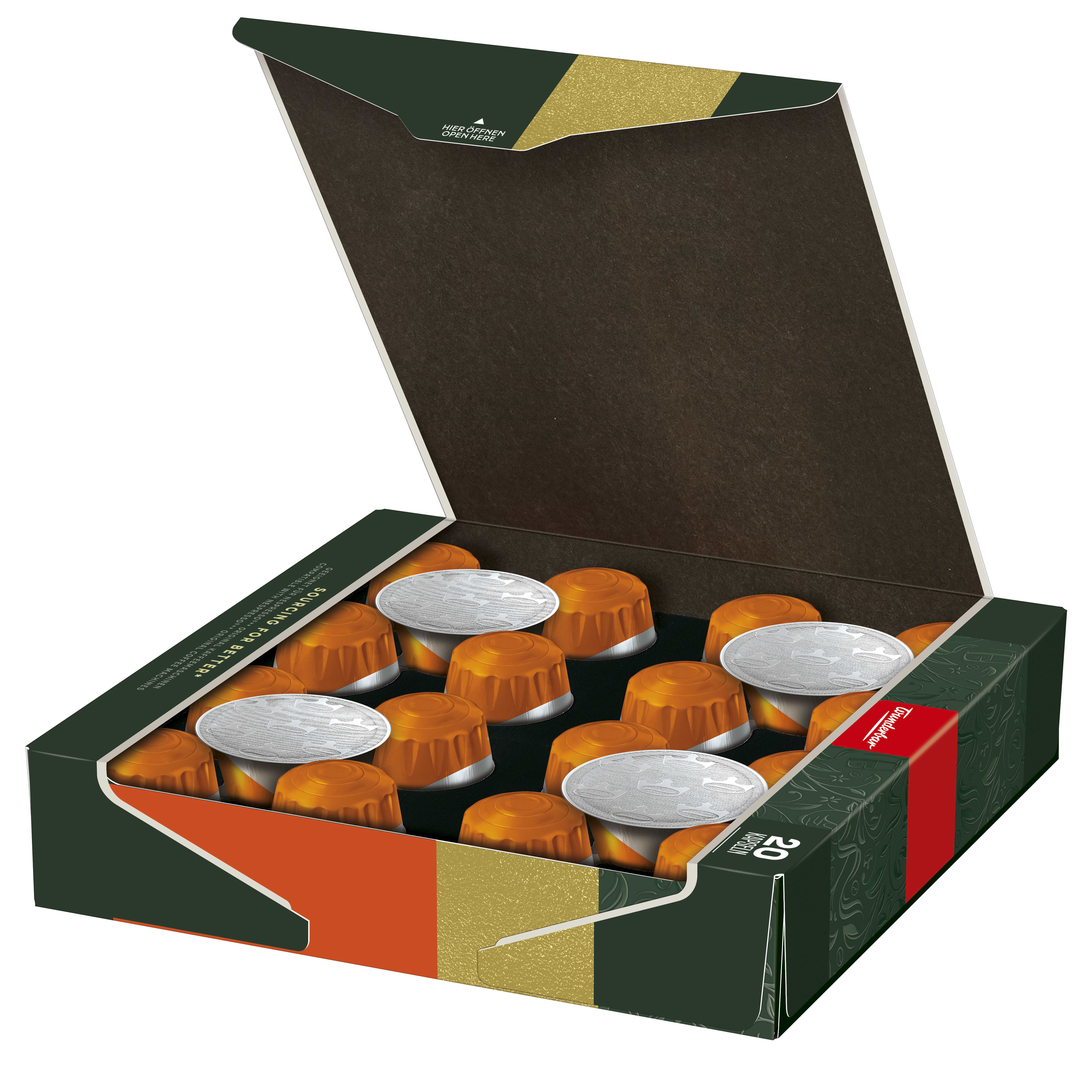 Schachtel mit Kaffeekapseln. Die Schachtel ist grün und gold mit rotem Streifen. Kapseln sind orange und silber.