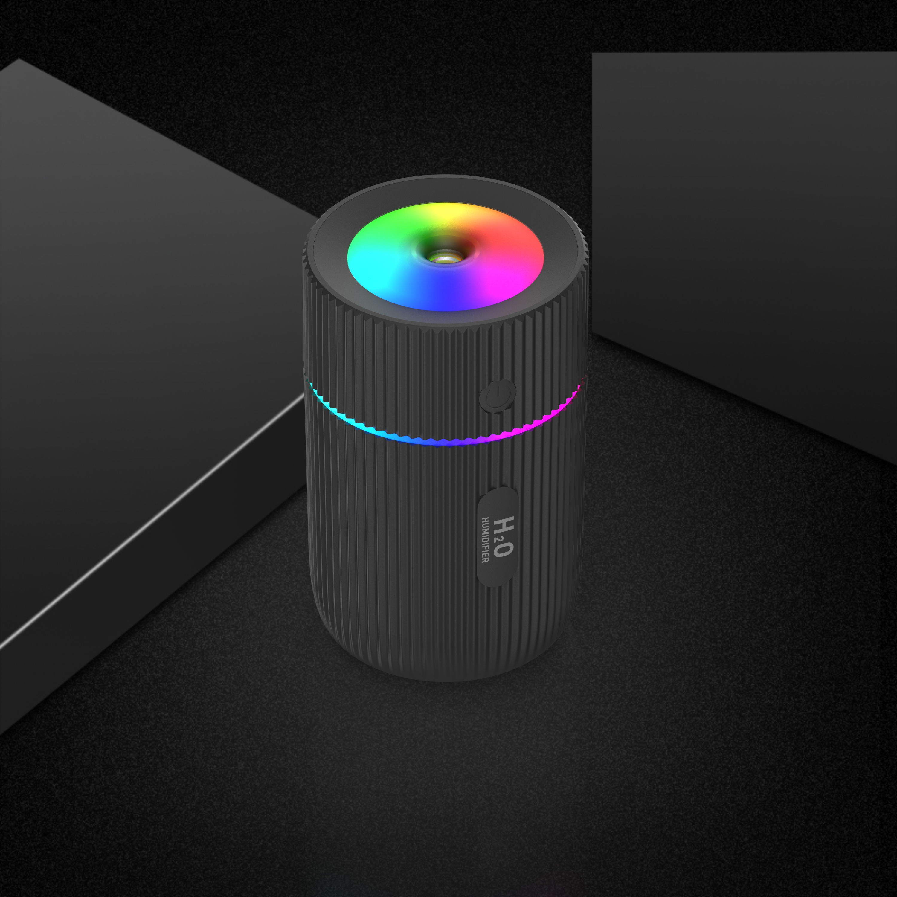 Humidificateur noir avec lumière colorée sur une surface sombre. Le texte H2O Humidifier est visible.