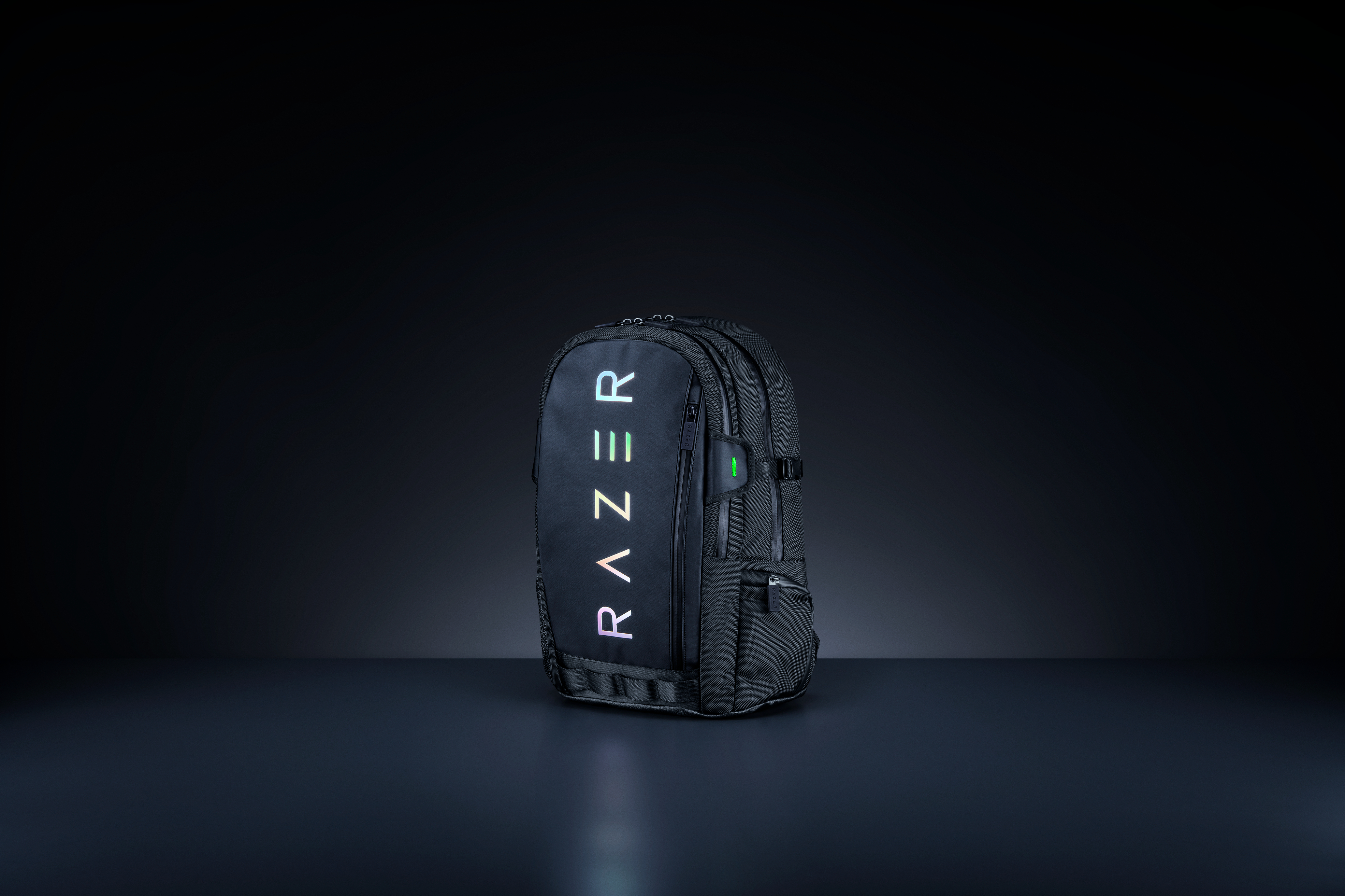 Black Razer backpack with the Razer logo in white and green. Dark background.