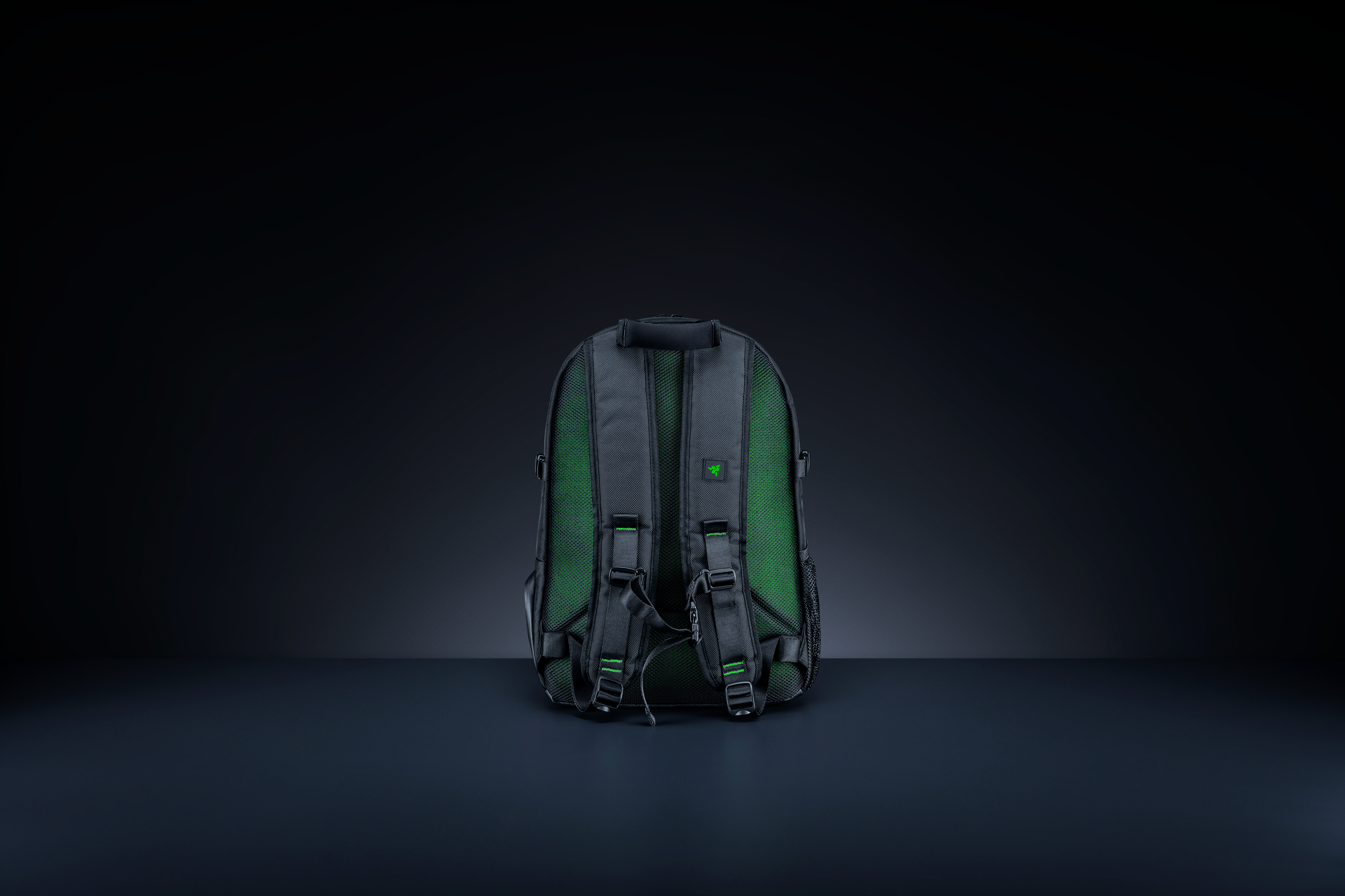 Black backpack from the back. Green accents. Razer logo.