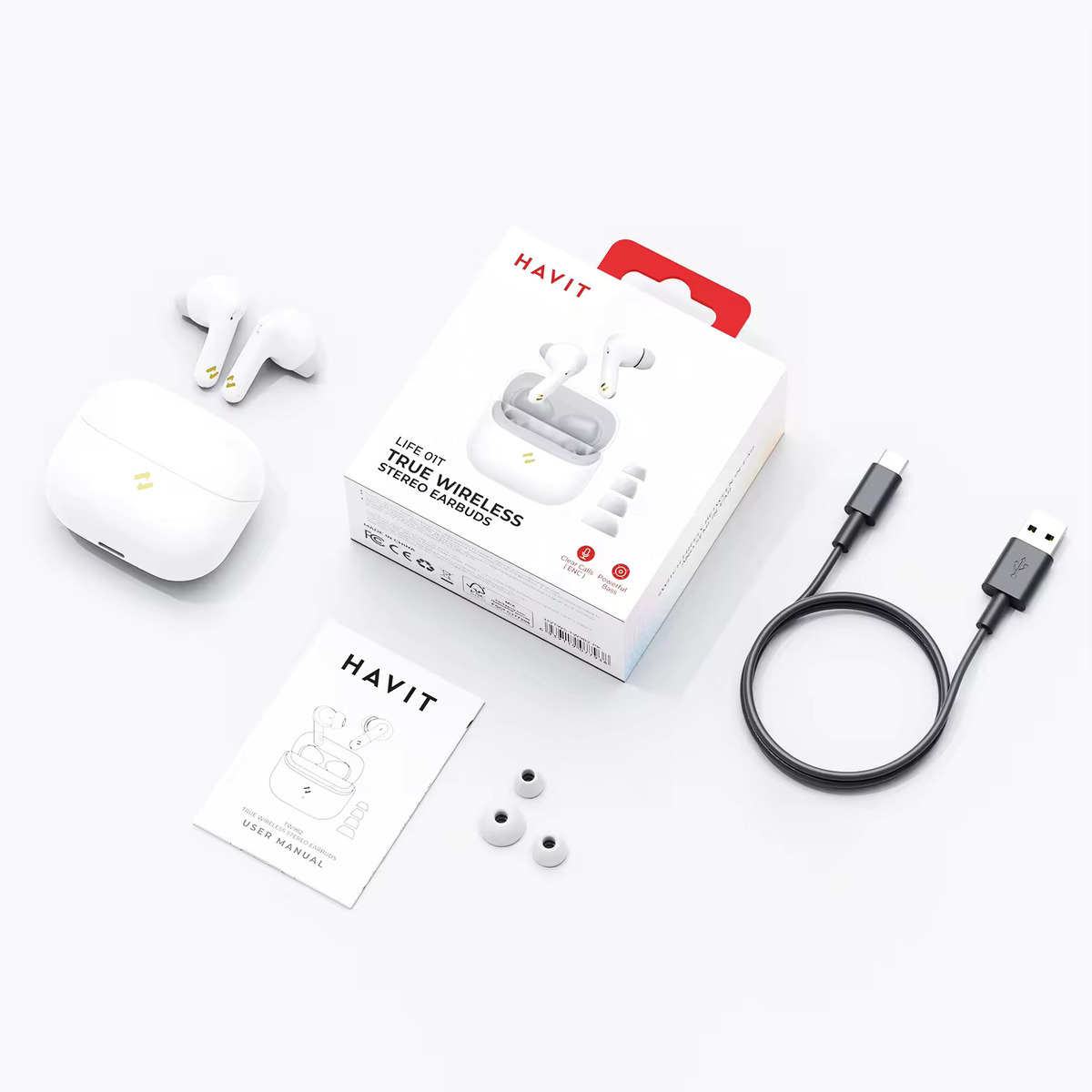Białe bezprzewodowe słuchawki douszne i etui ładujące z pudełkiem. Dołączono również kabel ładujący i instrukcję.