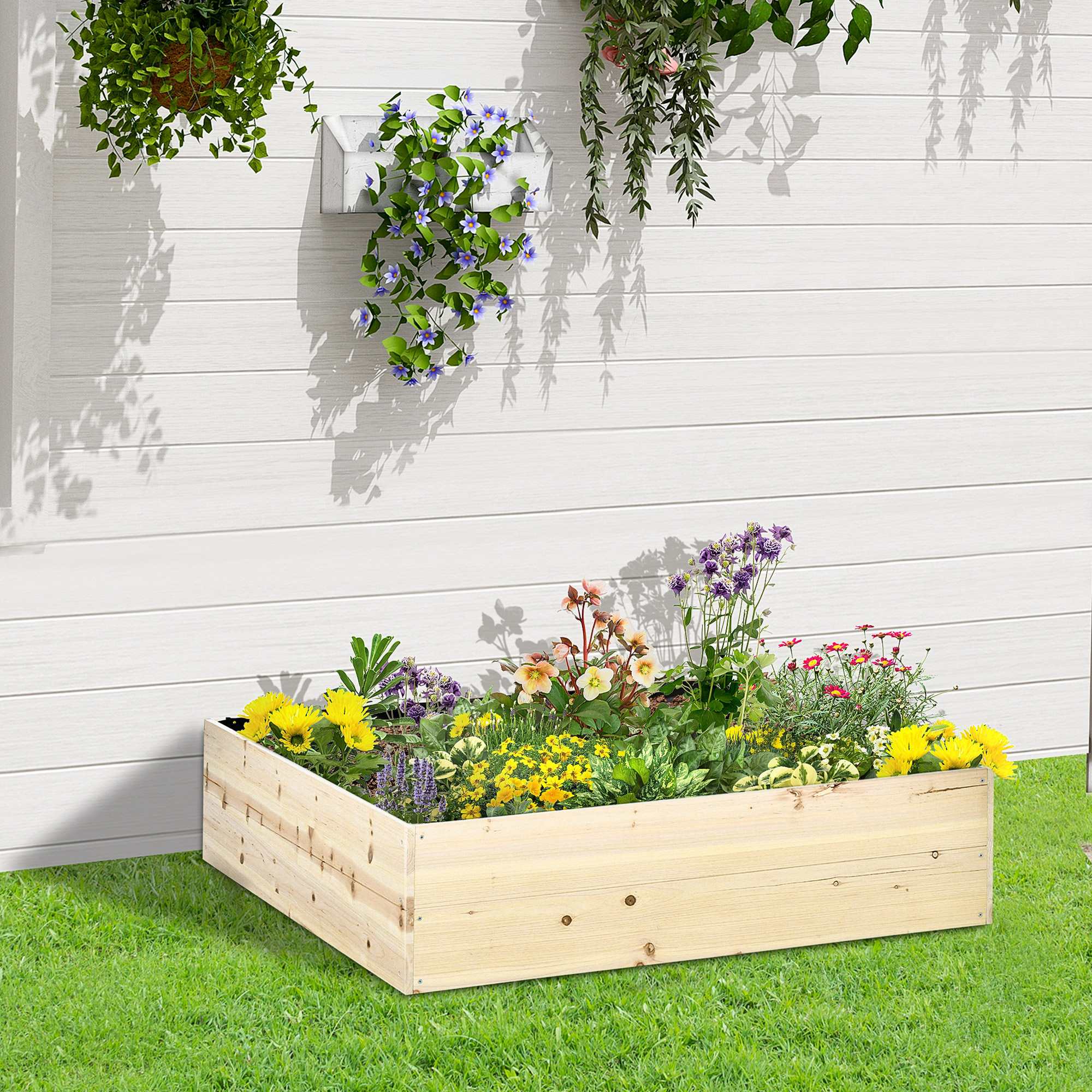 Aiuola rialzata in legno piena di fiori colorati. Muro bianco e piante sospese sullo sfondo.