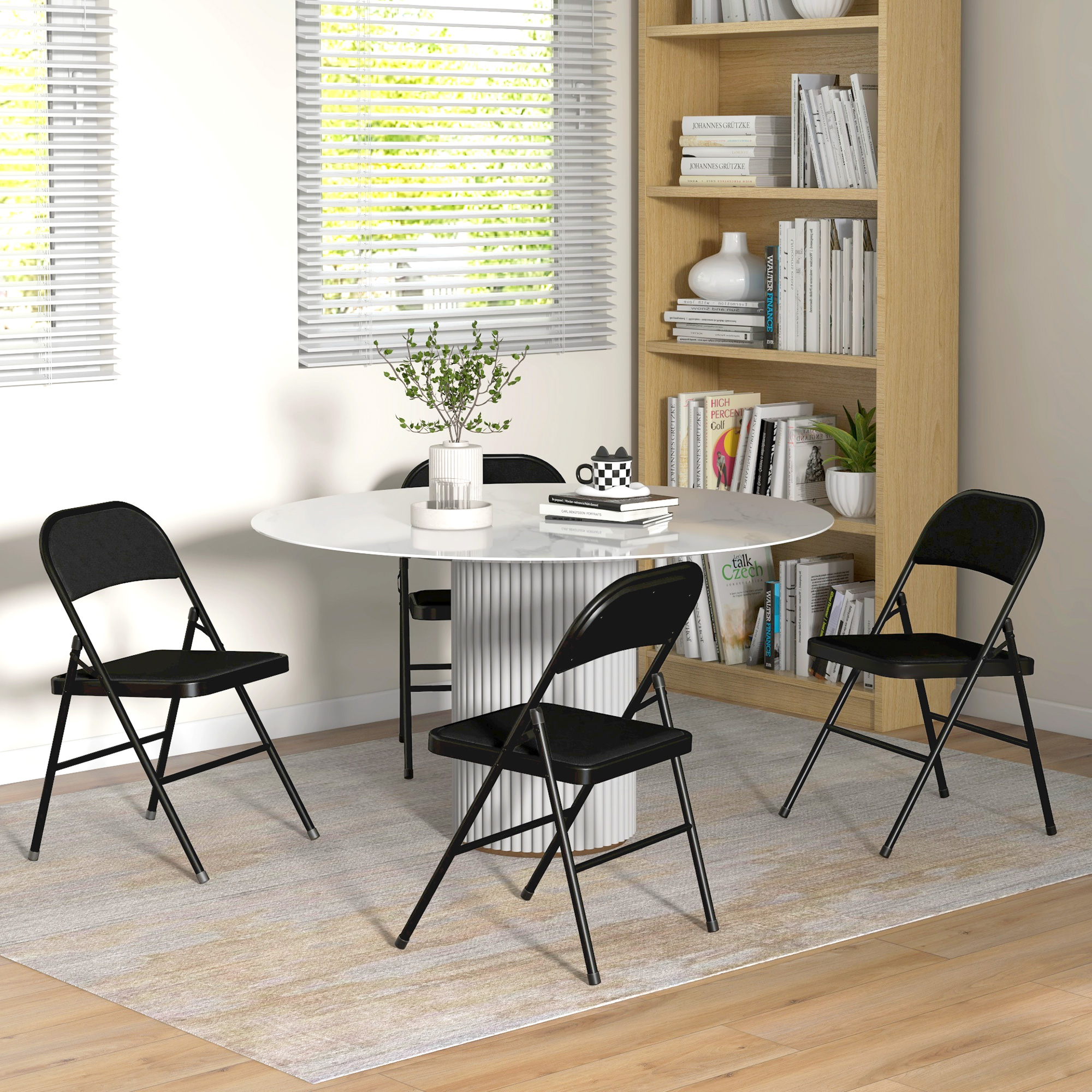 Sala da pranzo con tavolo rotondo bianco, quattro sedie pieghevoli nere, libreria e persiane.