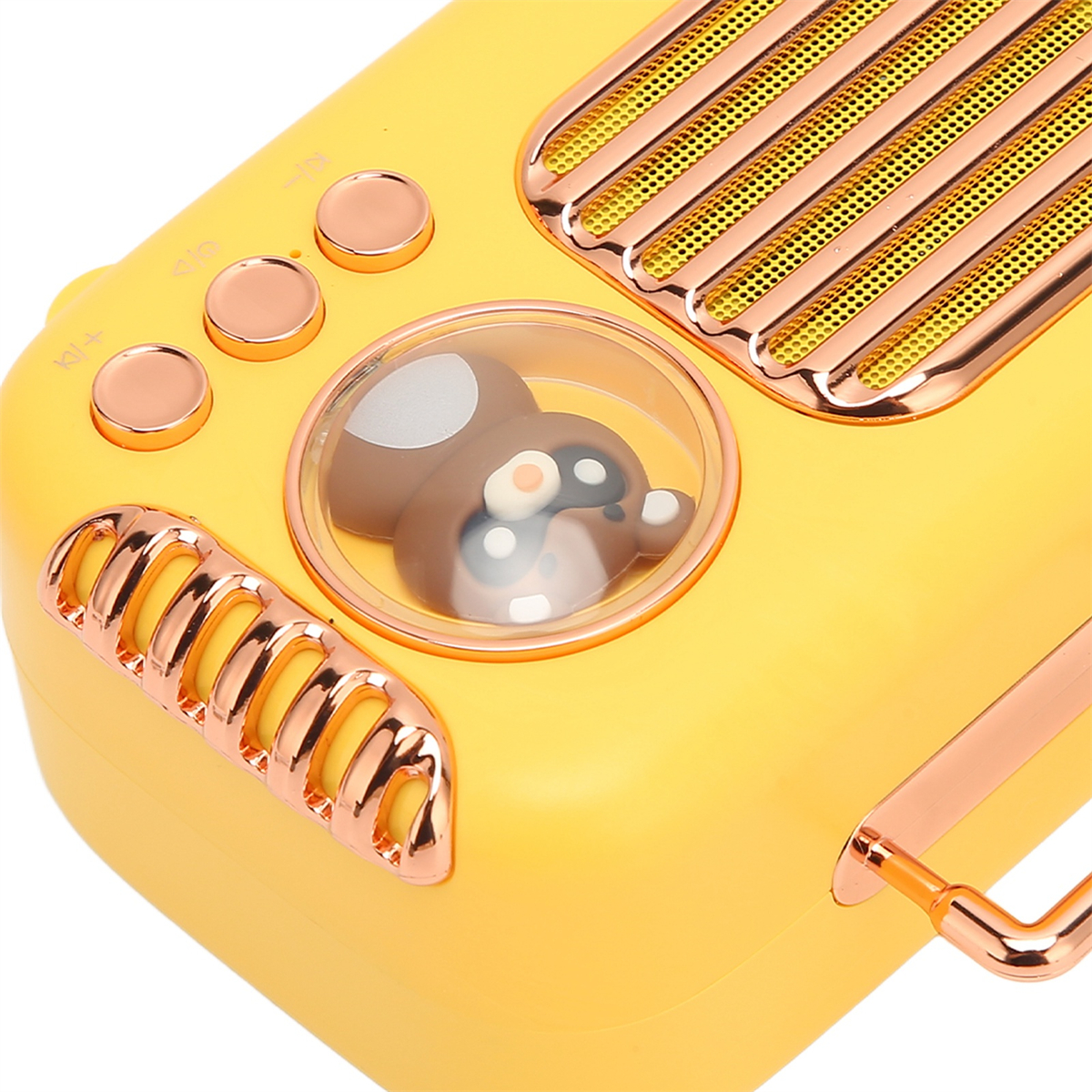 Gelbes Radio mit Bärenfigur in einer transparenten Kuppel und roségoldenen Akzenten.