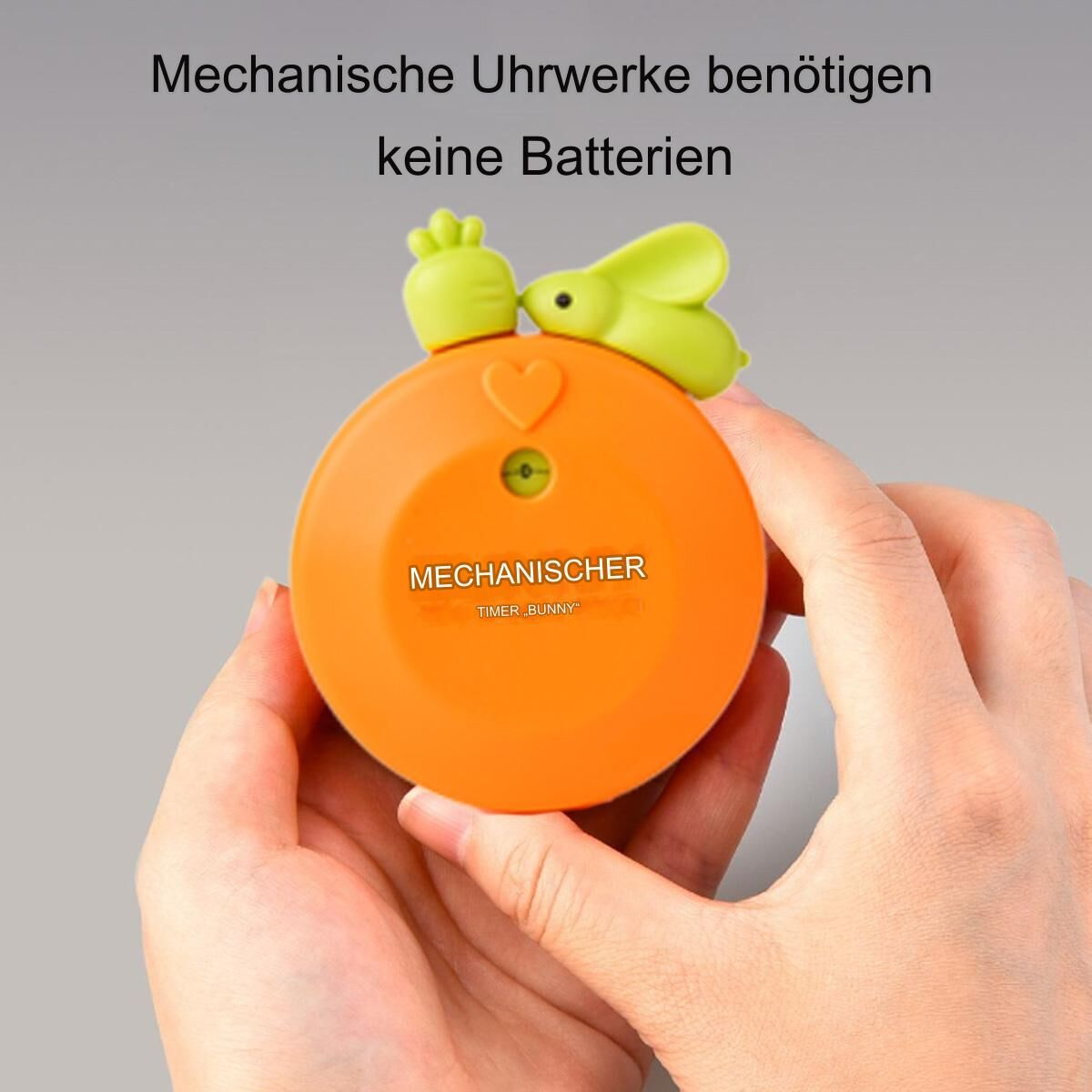 Orangener Küchentimer mit grünem Hasen, Herz und Text 'MECHANISCHER TIMER BUNNY'.