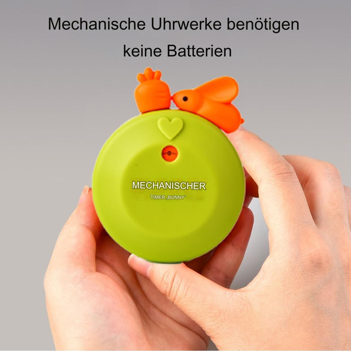 Grüner mechanischer Timer mit Hasen- und Karottendetails und Text auf Deutsch.