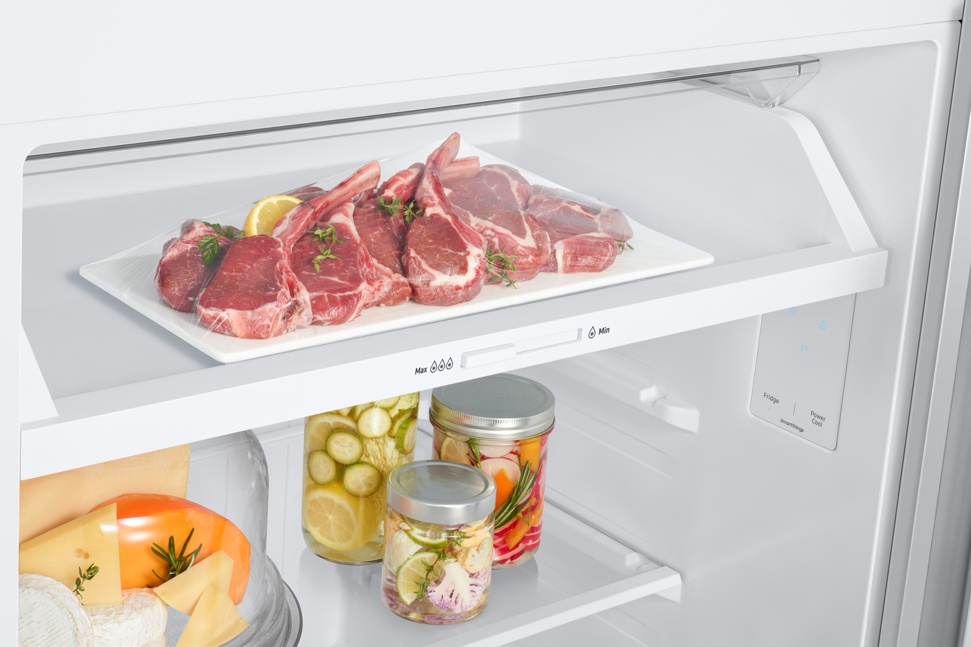 Refrigerator shelf with food: raw meat, pickles in jars, and cheese.