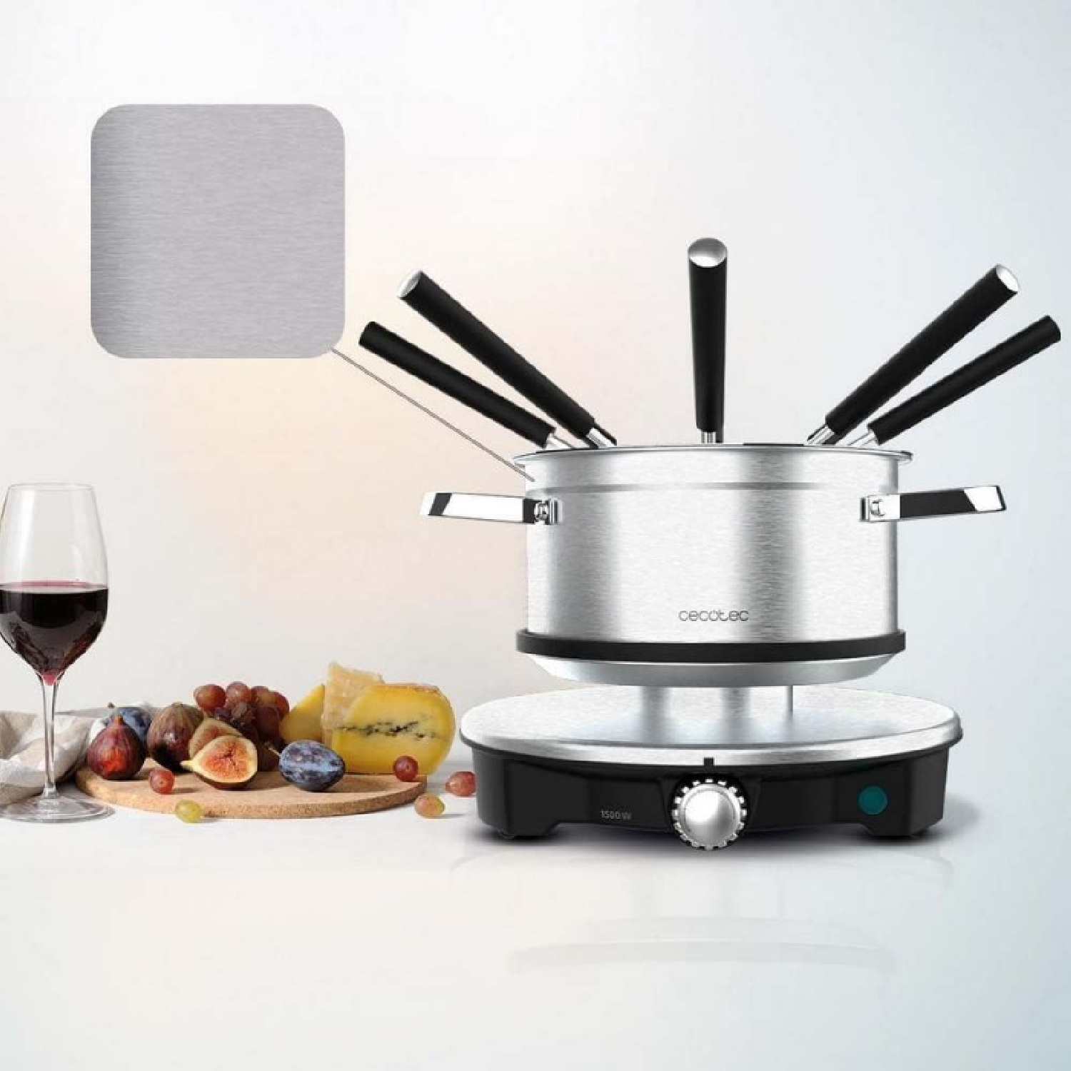 A fondue set with a pot, forks, and a cutting board with fruit and cheese.