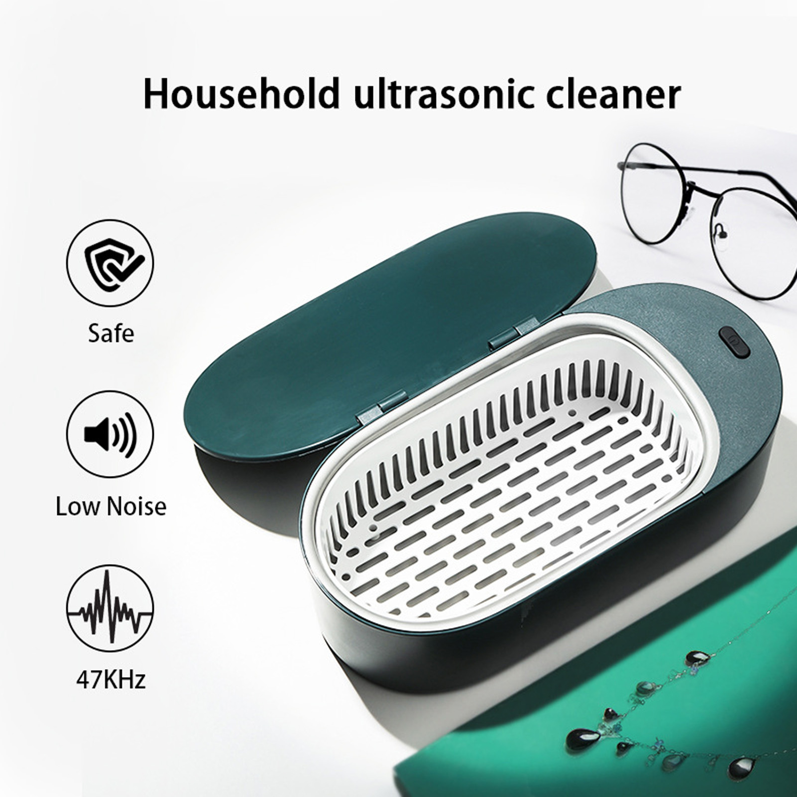 Ultraschallreiniger für den Haushalt mit Zubehör, grüner Koffer und weißem Korb. Brille liegt daneben.