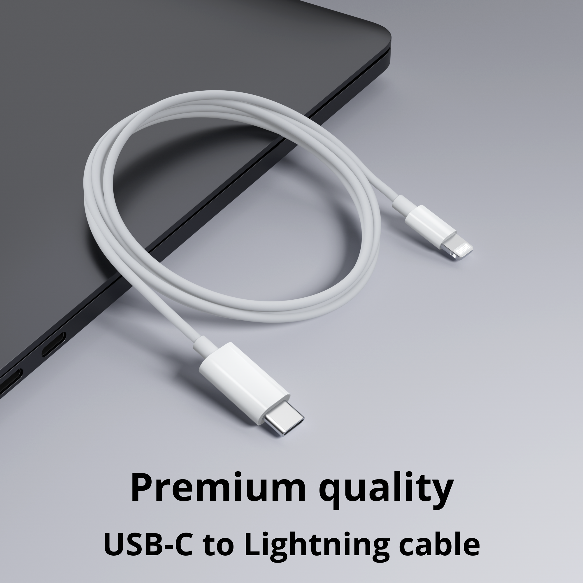 A white USB-C to Lightning cable on a grey surface next to a laptop.
