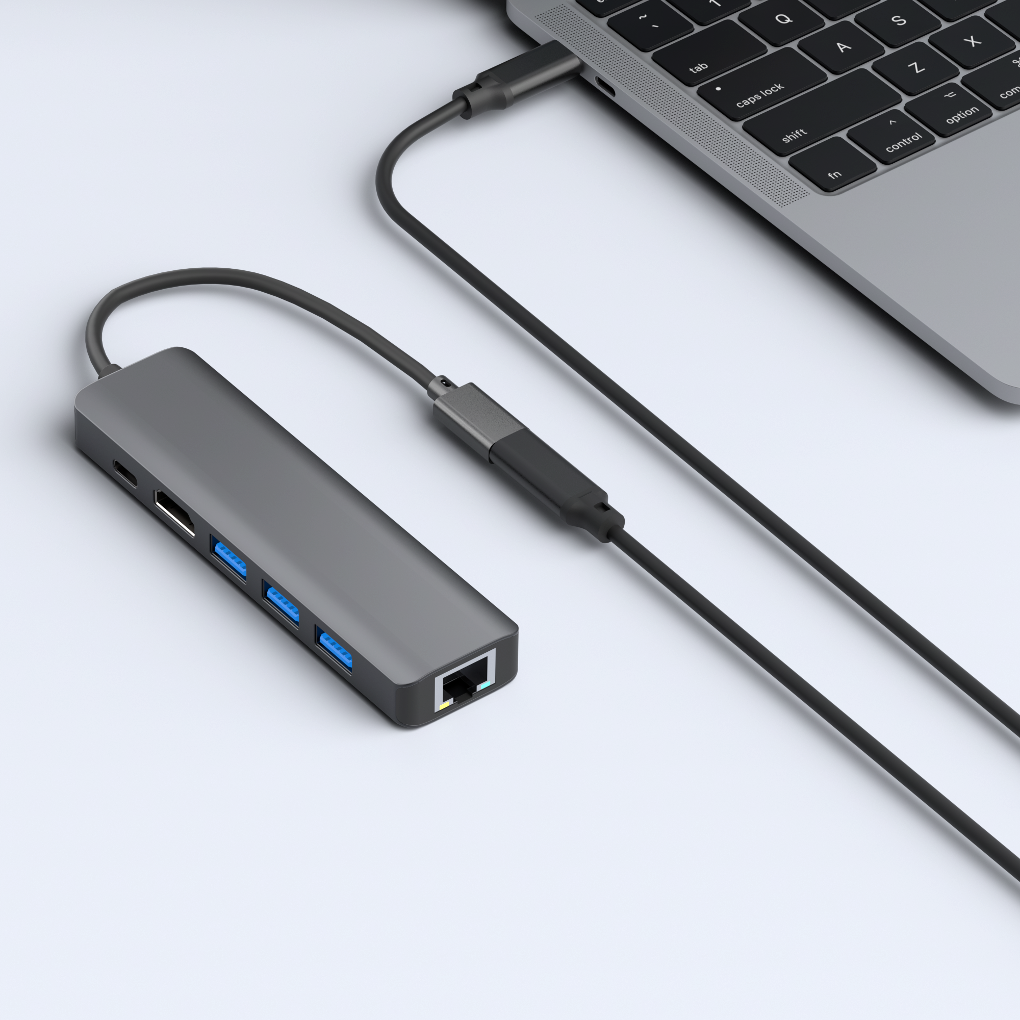 Een grijze USB-hub aangesloten op een laptop met meerdere poorten en een kabel.