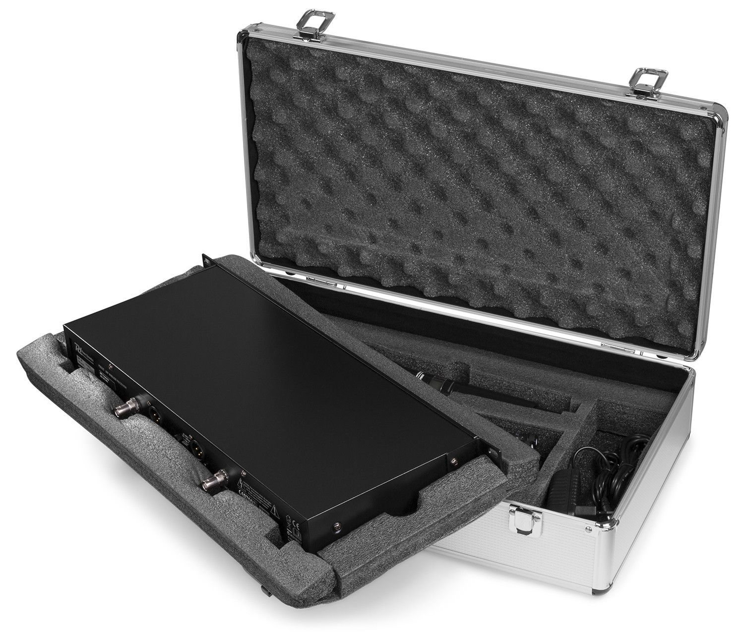 A black device sits in a silver case with foam padding. The case is open, revealing the device and accessories.