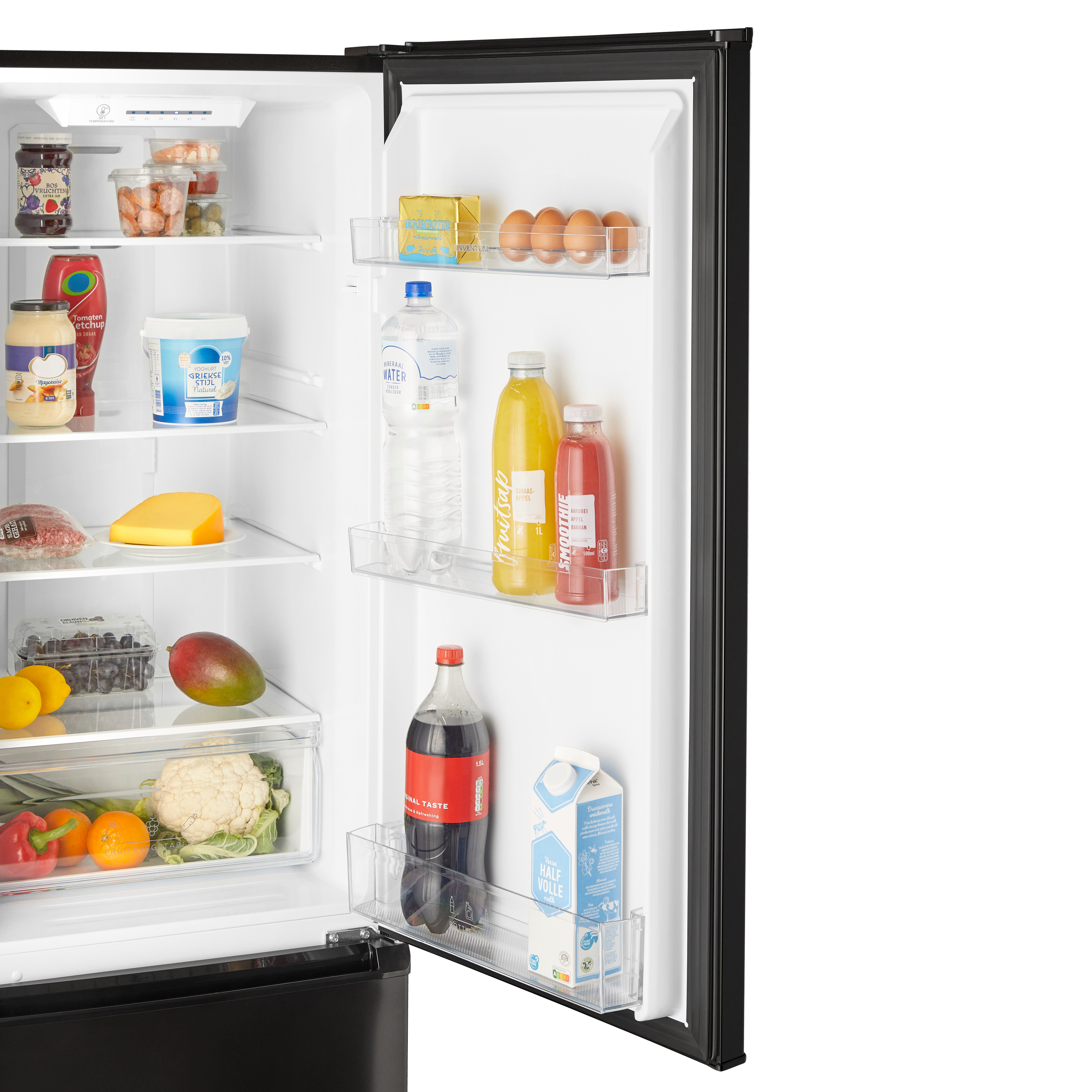 Refrigerator interior. Contains food items like water bottles, juice, eggs, and vegetables.