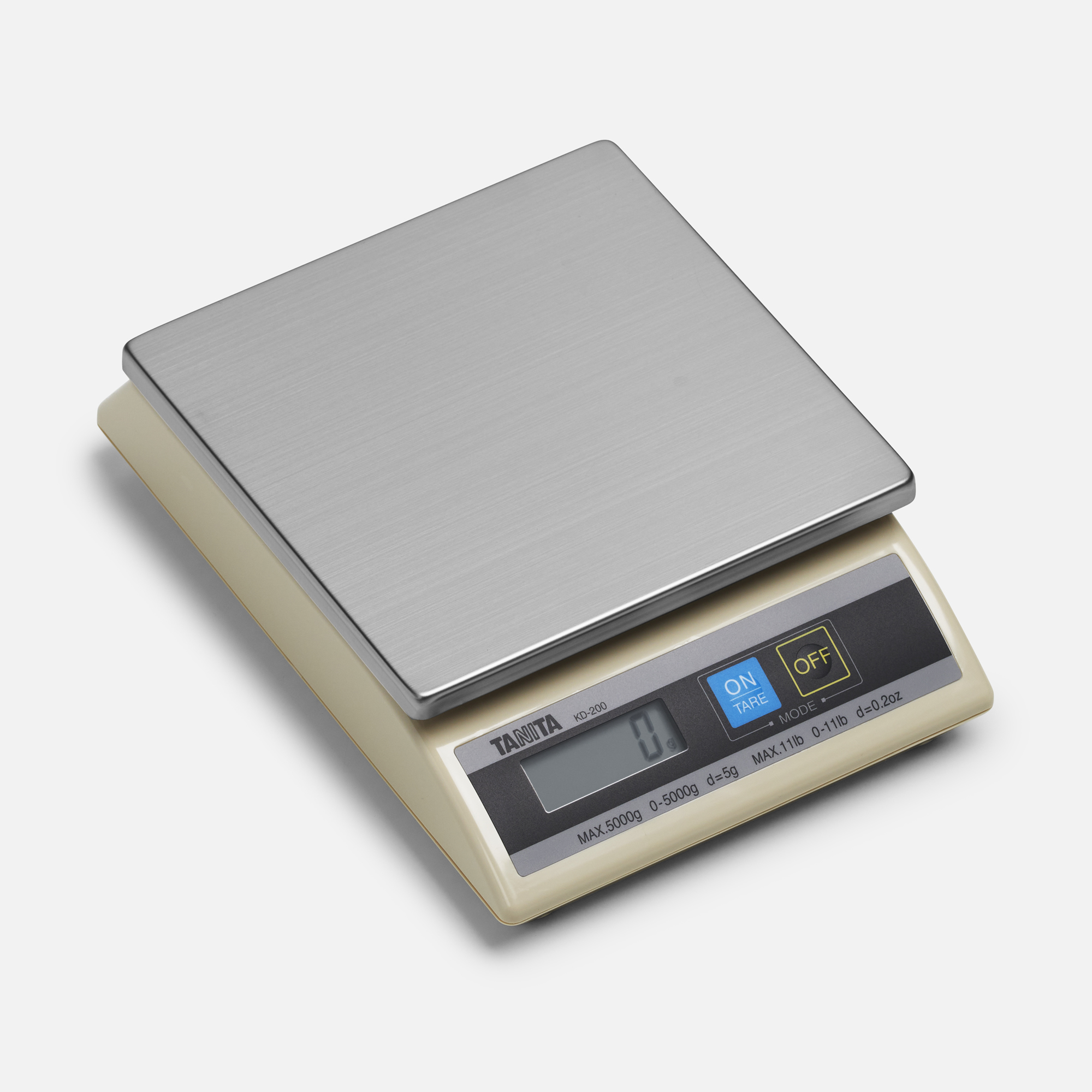 Digital kitchen scale. Stainless steel top, beige body, digital display. White background.