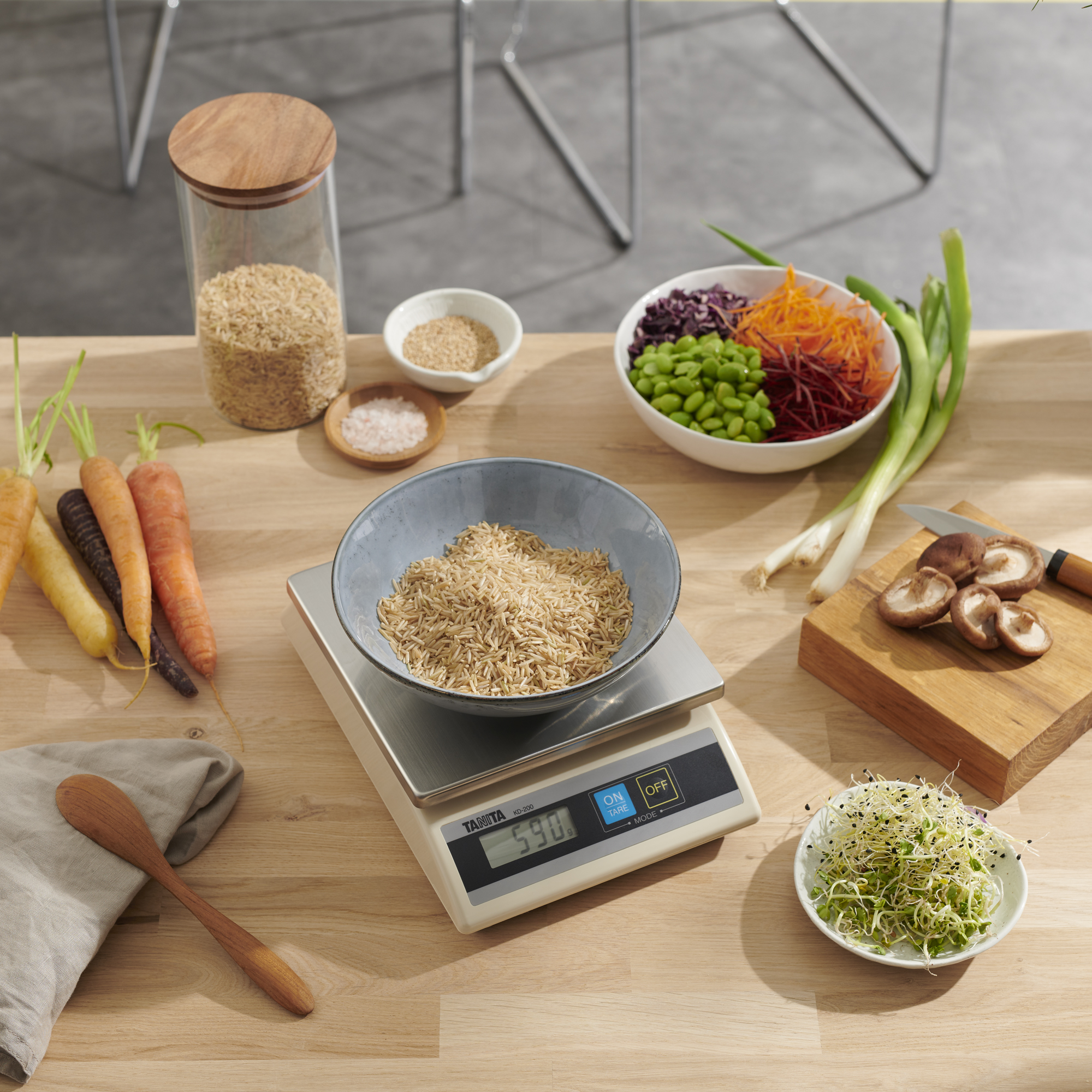 Kitchen counter with various ingredients, scale, and utensils.
