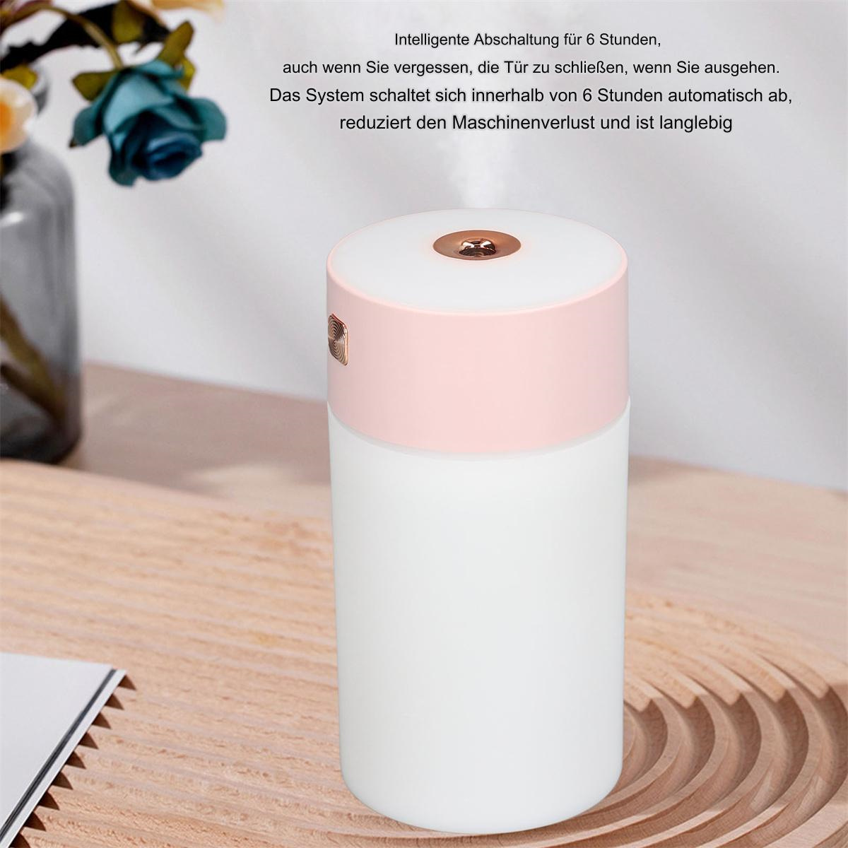 Weißer und rosa Luftbefeuchter mit rosa Oberteil und weißer Basis, der auf einem Holztisch steht.