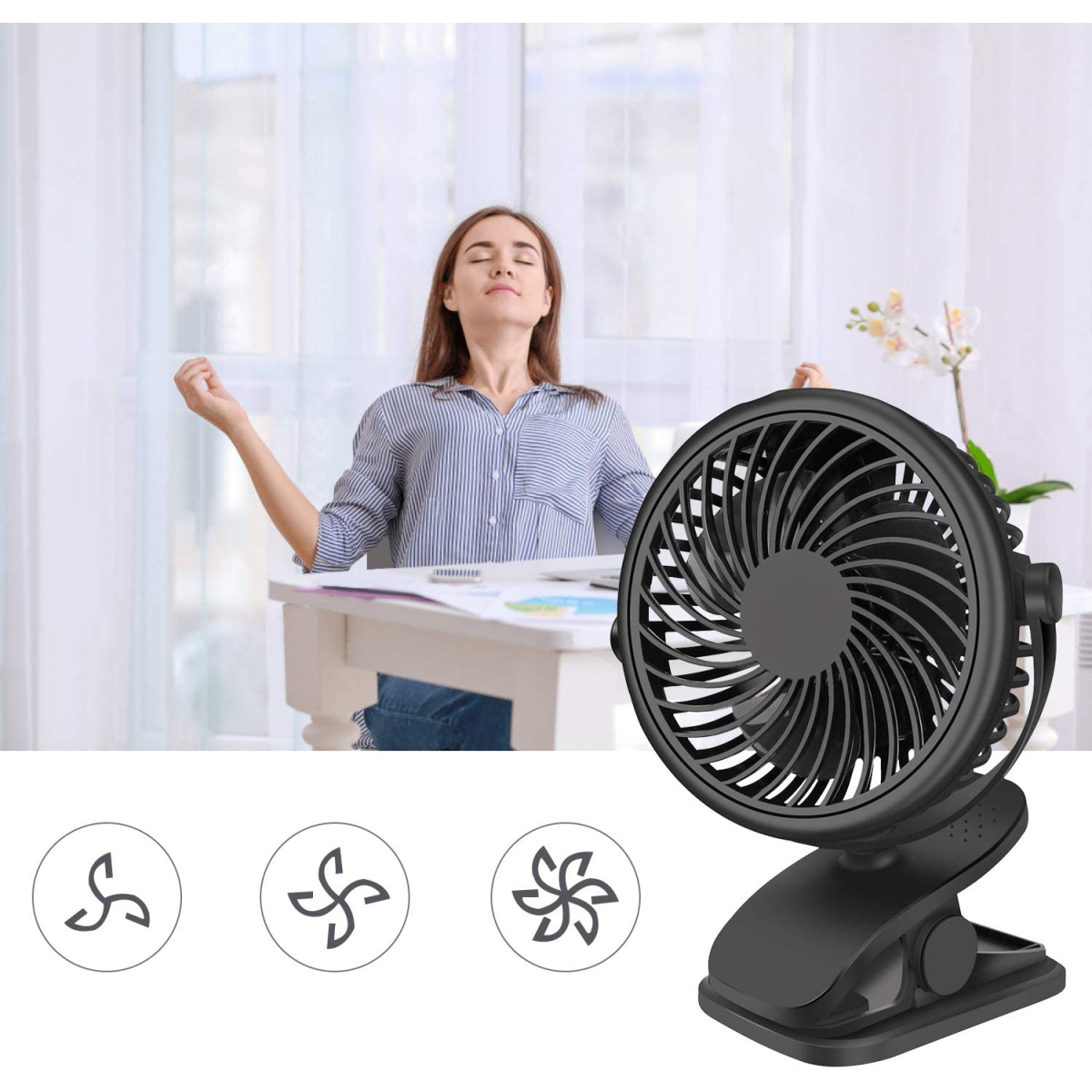 Ein schwarzer Clip-on-Ventilator mit einer Frau im Hintergrund.