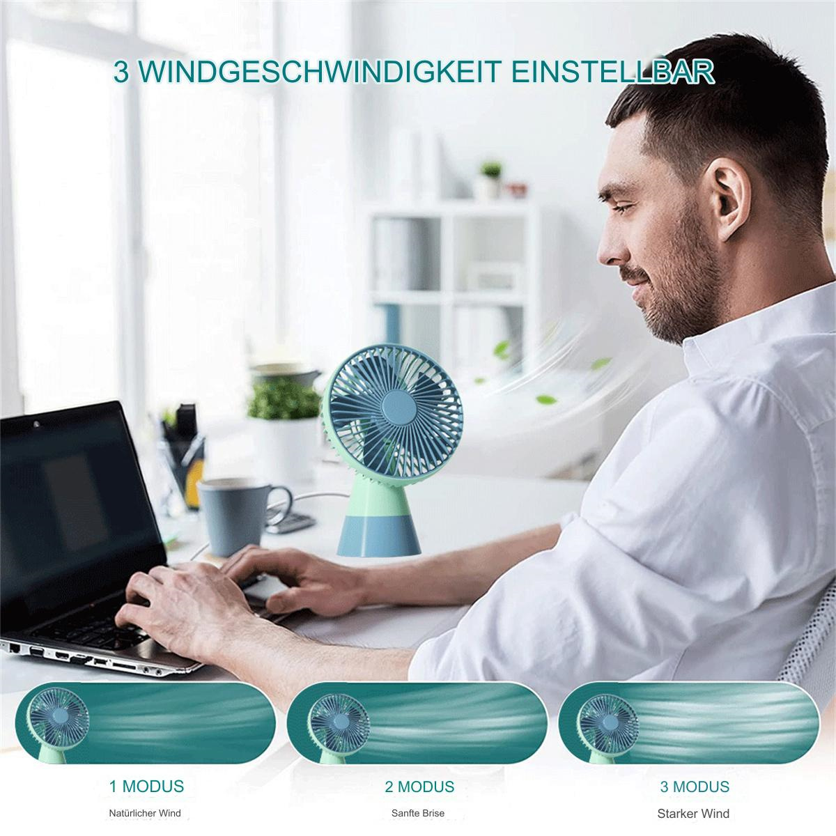 Ein Mann sitzt am Schreibtisch mit Laptop und kleinem Ventilator. Der Ventilator hat 3 Windgeschwindigkeiten.
