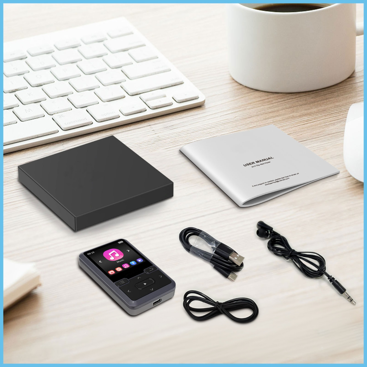 Ein Schreibtisch mit einem kleinen MP3-Player, Bedienungsanleitung, Kabeln und Tastatur.