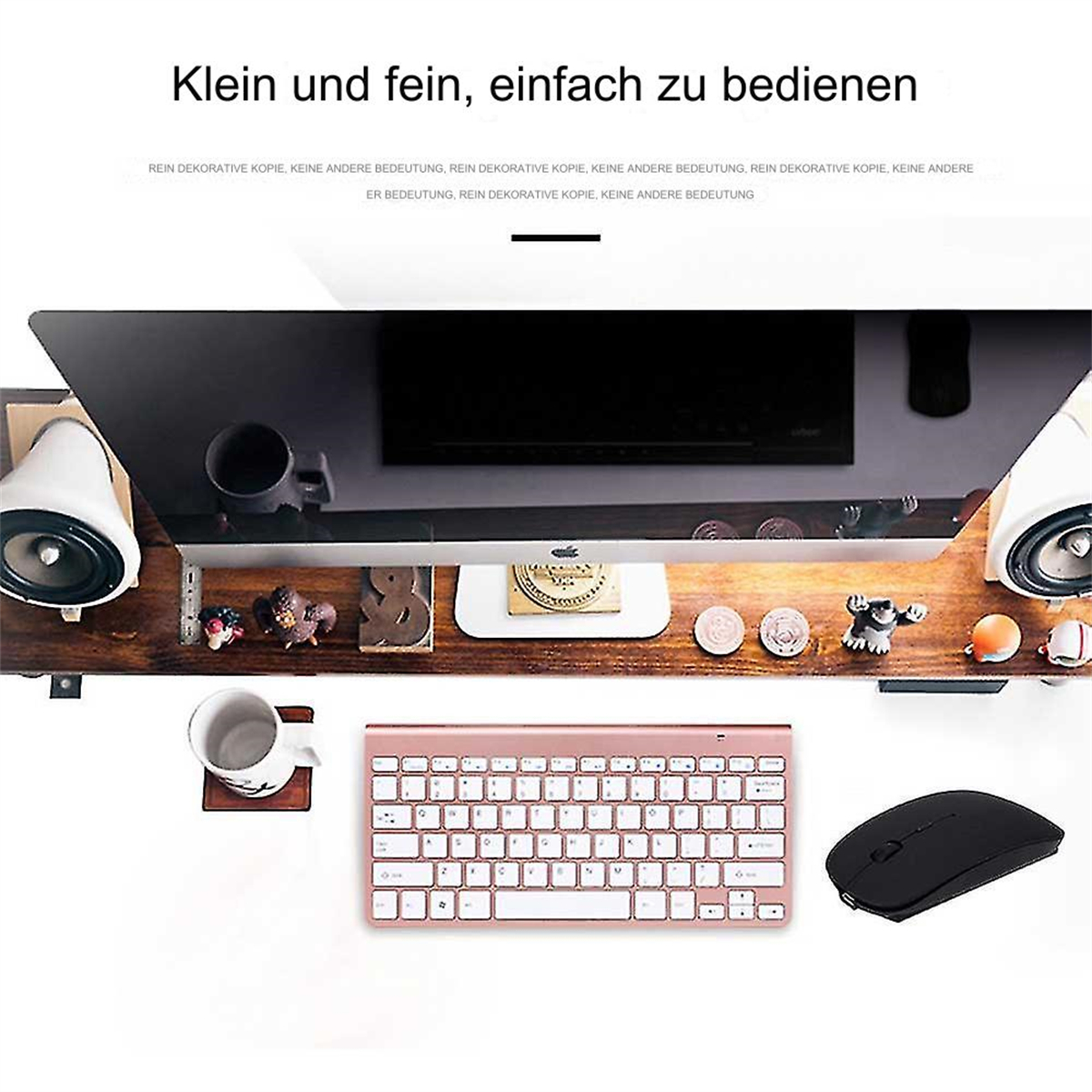 Ein Schreibtisch mit Tastatur, Maus, Lautsprechern und einem Computermonitor.