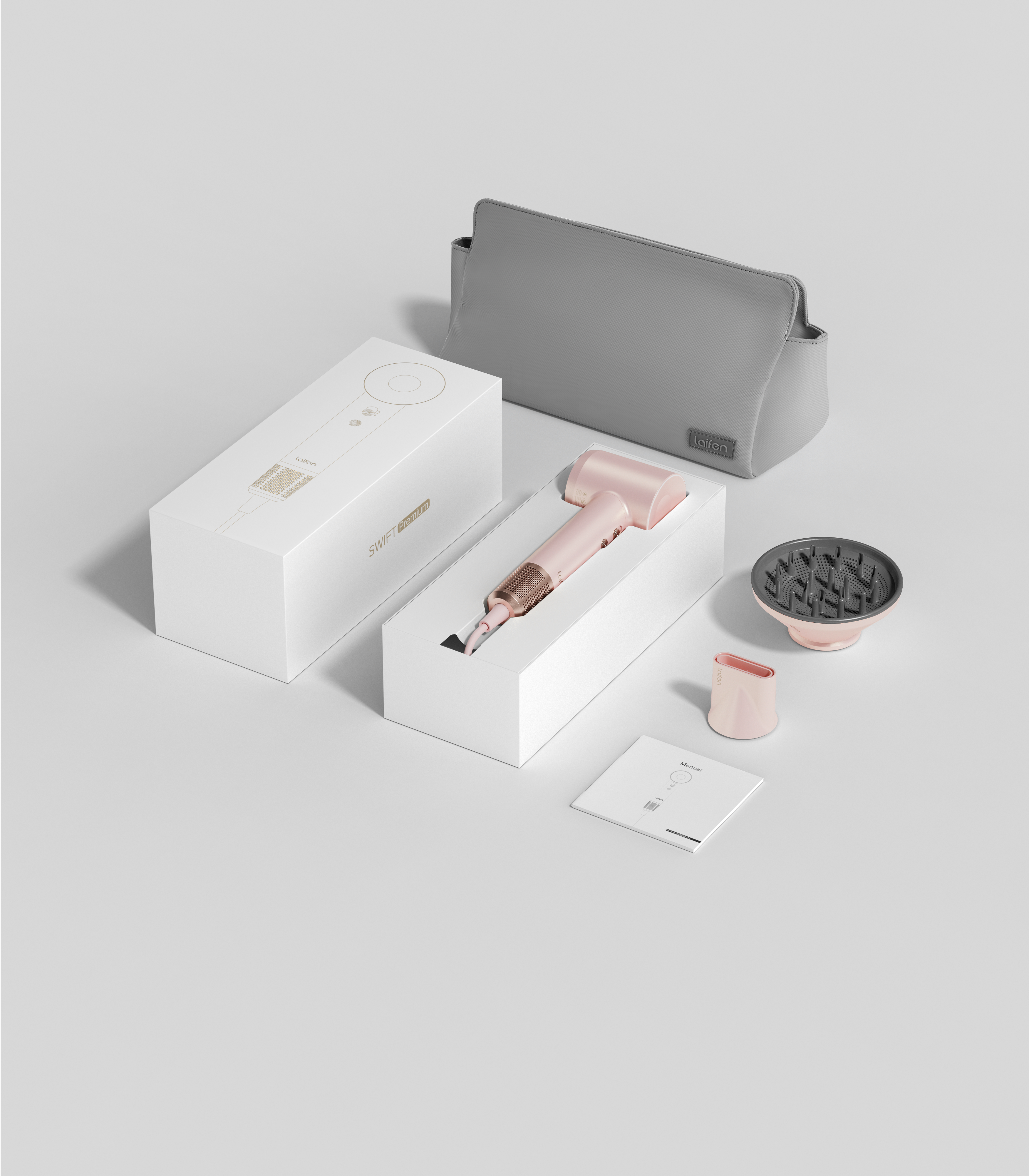 Scatola prodotto con asciugacapelli rosa e accessori, ordinatamente disposti su superficie bianca.