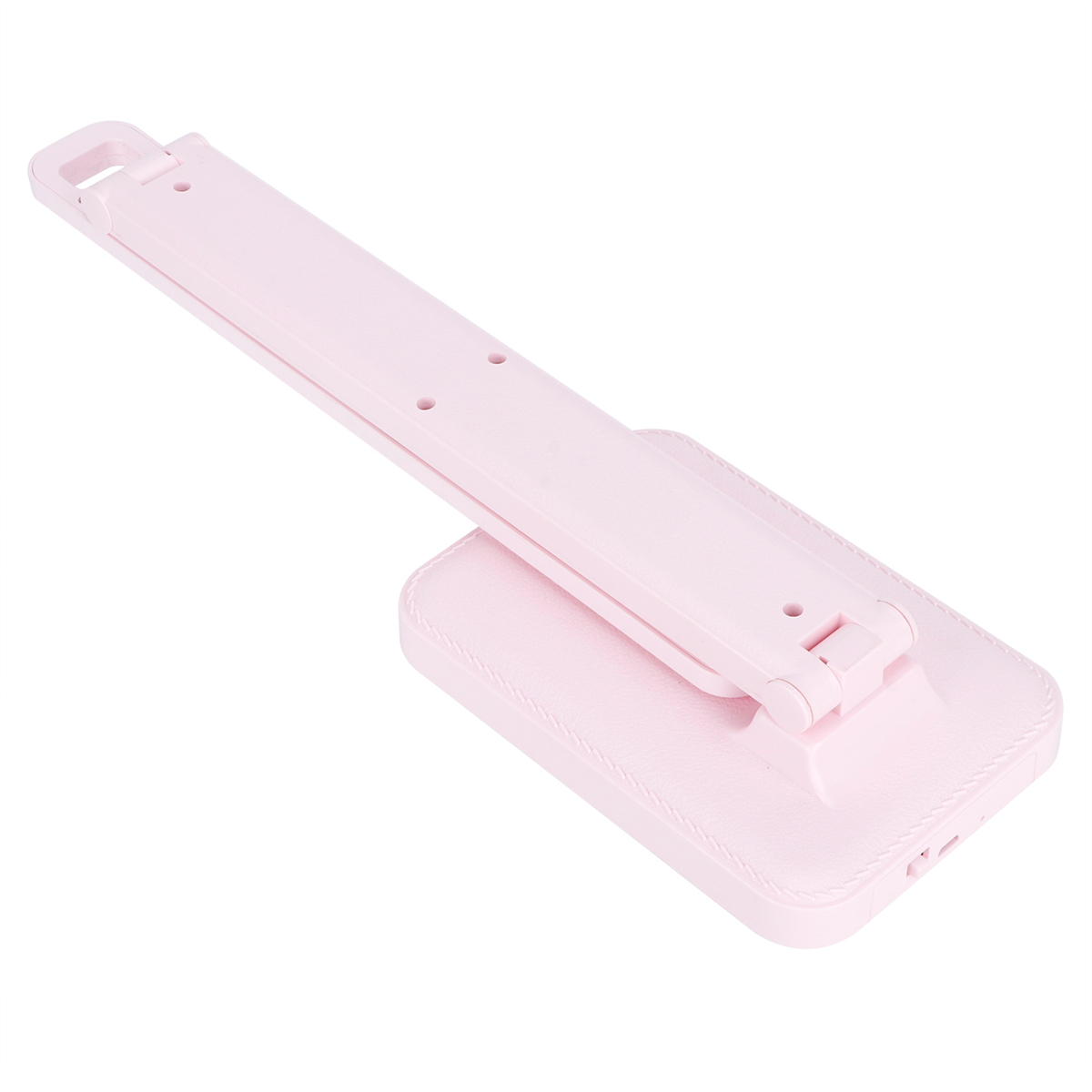 Eine pinkfarbene, faltbare Schreibtischlampe, schräg dargestellt. Der Sockel hat Lederstruktur.