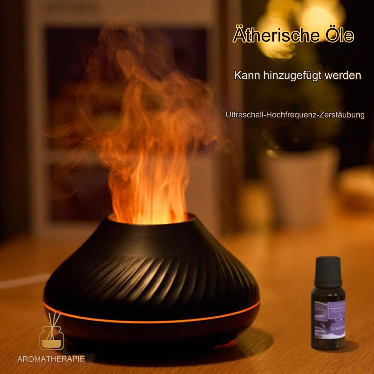 Schwarzer Diffusor mit orangefarbenem, flammenartigem Dampf. Aromatherapie-Ölflasche daneben.