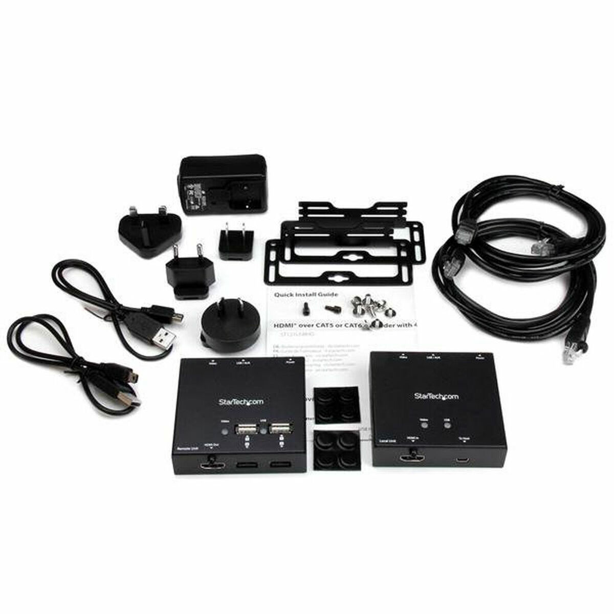Varios equipos electrónicos, incluyendo cajas StarTech, cables y enchufes. Fondo blanco.