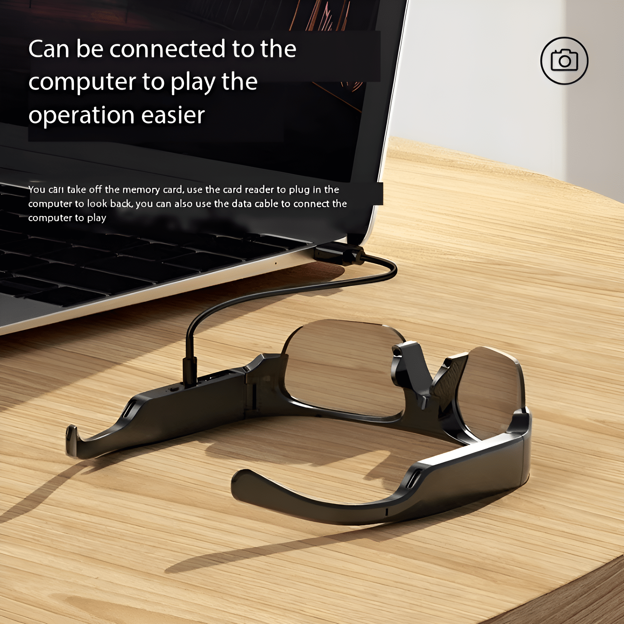 Eine schwarze Smart-Brille, die mit einem Datenkabel an einen Laptop angeschlossen ist.