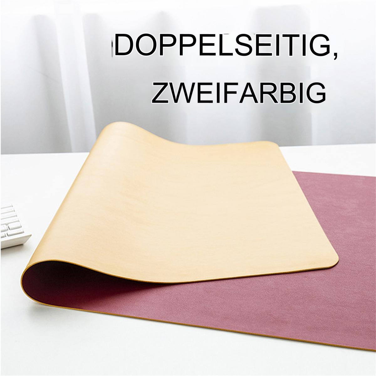 Eine beige und weinrote Schreibtischunterlage auf einem weißen Schreibtisch. Die Unterlage ist rechteckig und zweifarbig.