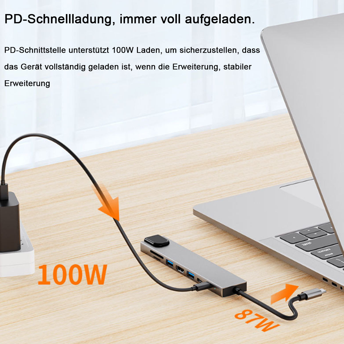 Ein Laptop ist über ein schwarzes Kabel mit einem grauen USB-Hub verbunden. Der Hub ist mit einer Steckdose verbunden. Text liest sich '100W' und '87W'.