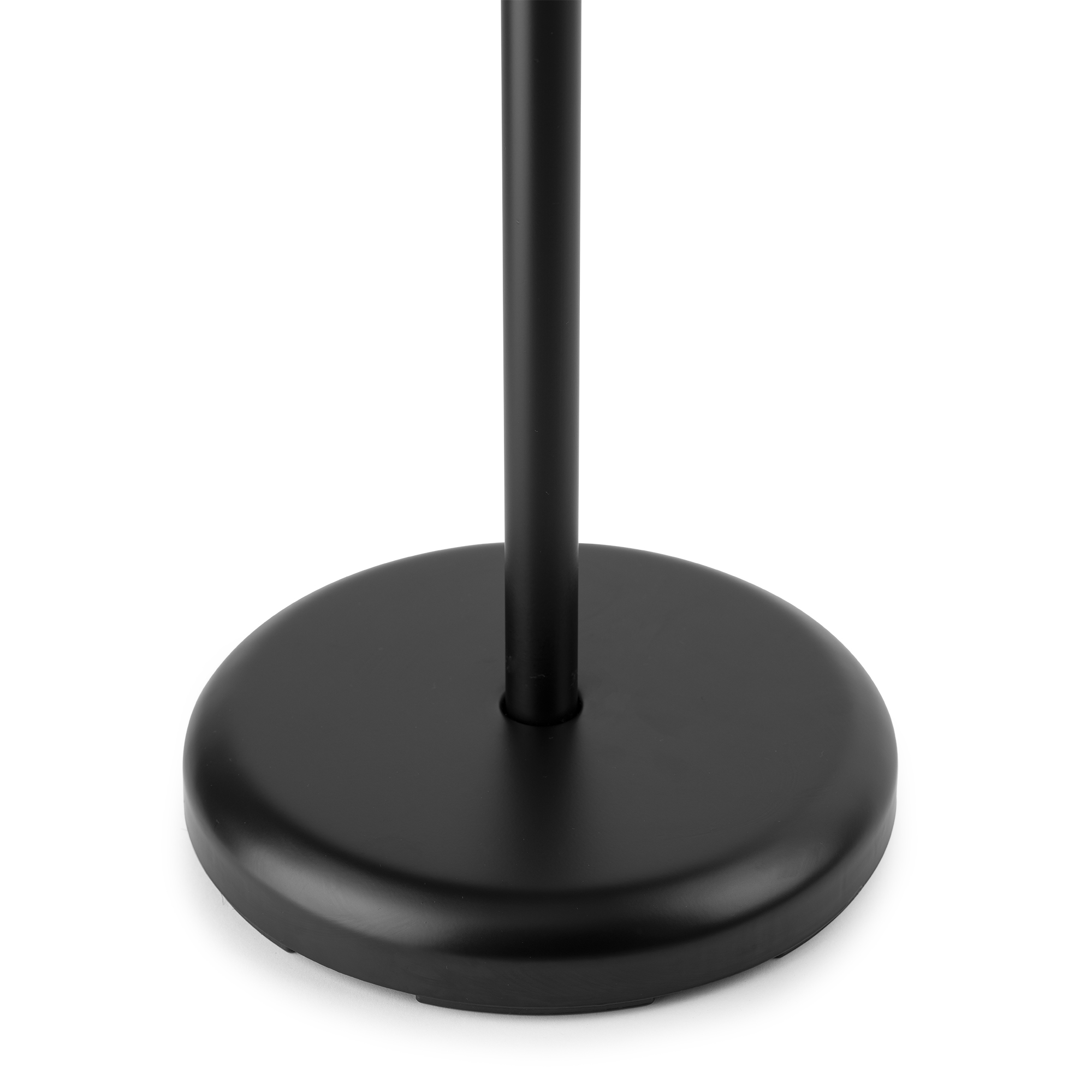 A black metal microphone stand base. It is round and has a black pole in the center.