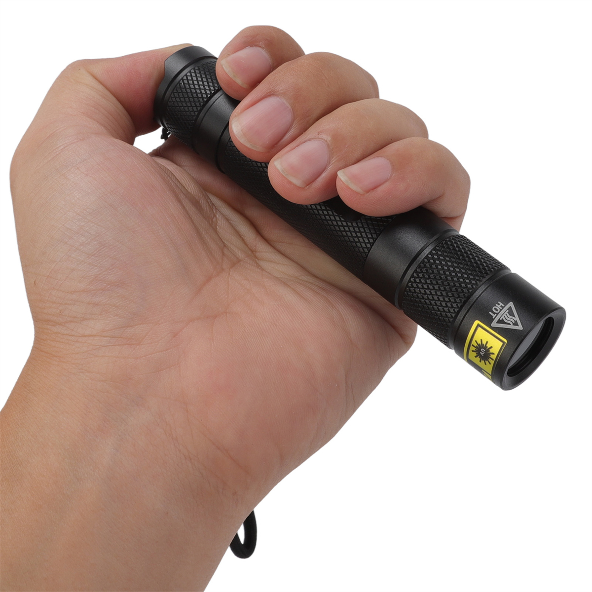 Eine Hand, die eine schwarze Taschenlampe hält. Sie hat ein Laser-Warnschild. Weißer Hintergrund.
