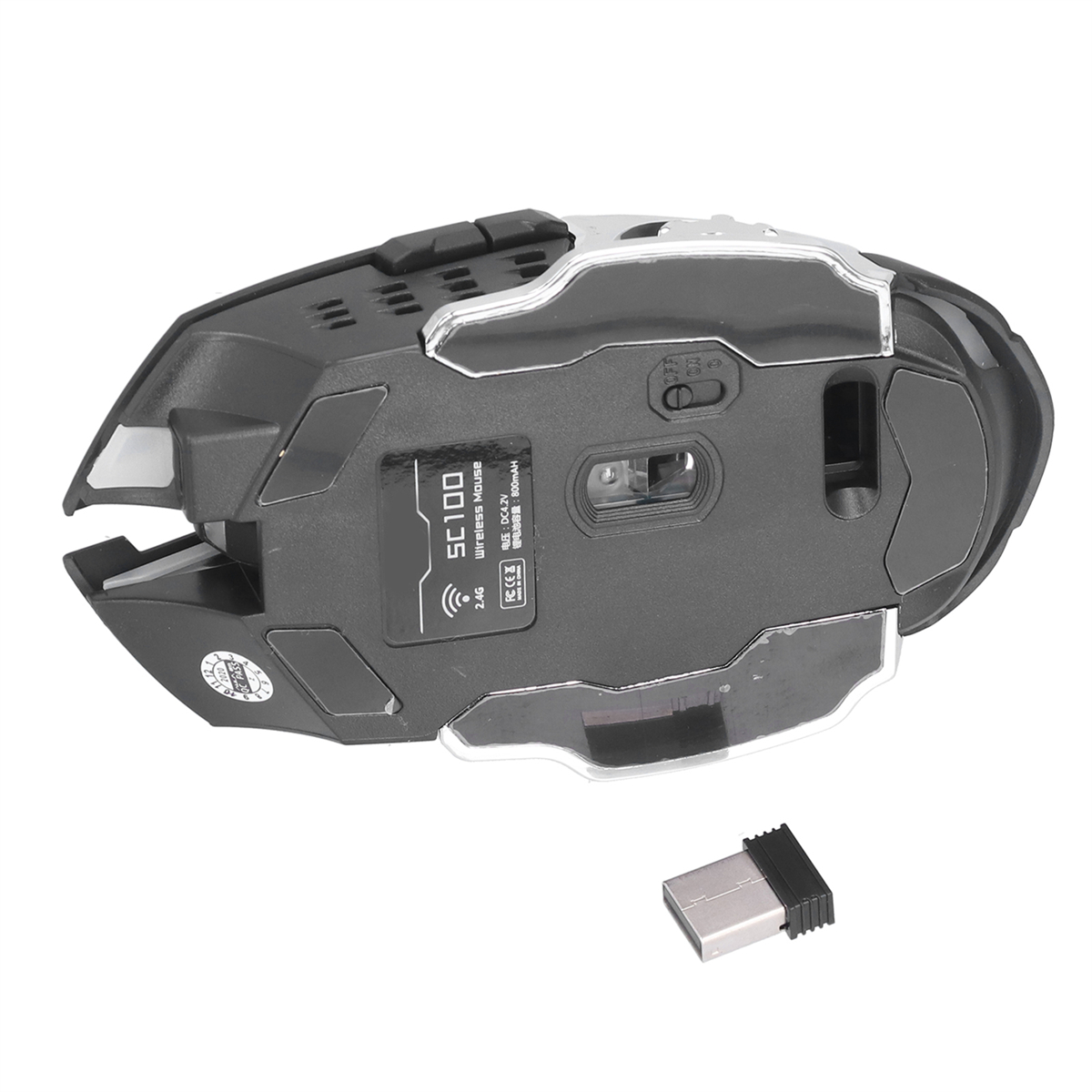 Kabellose Maus, schwarz mit silbernen Akzenten, und ein USB-Empfänger daneben. Draufsicht.
