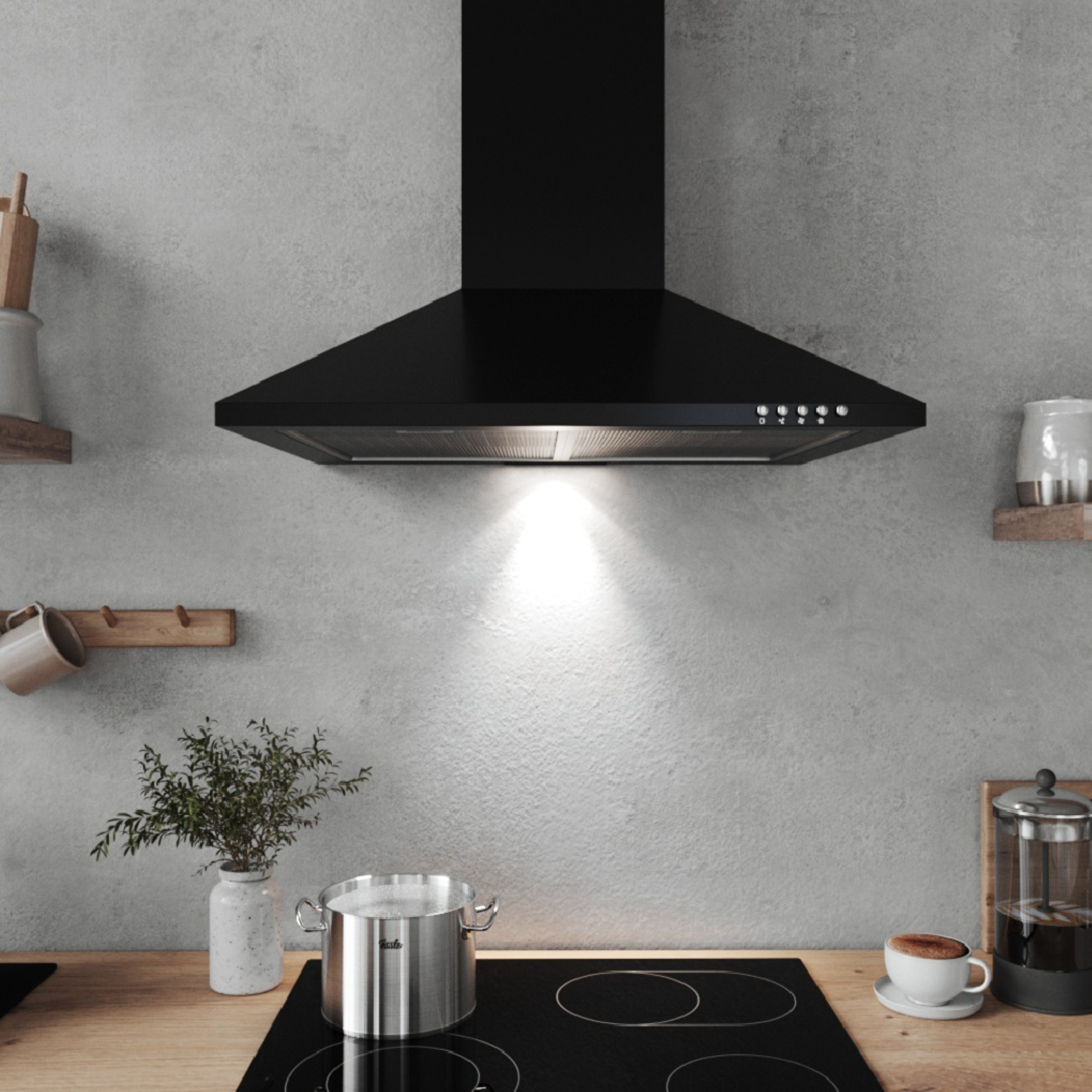 Zwarte afzuigkap boven kookplaat, met pan en koffiekopje. Houten aanrecht, neutrale muren.