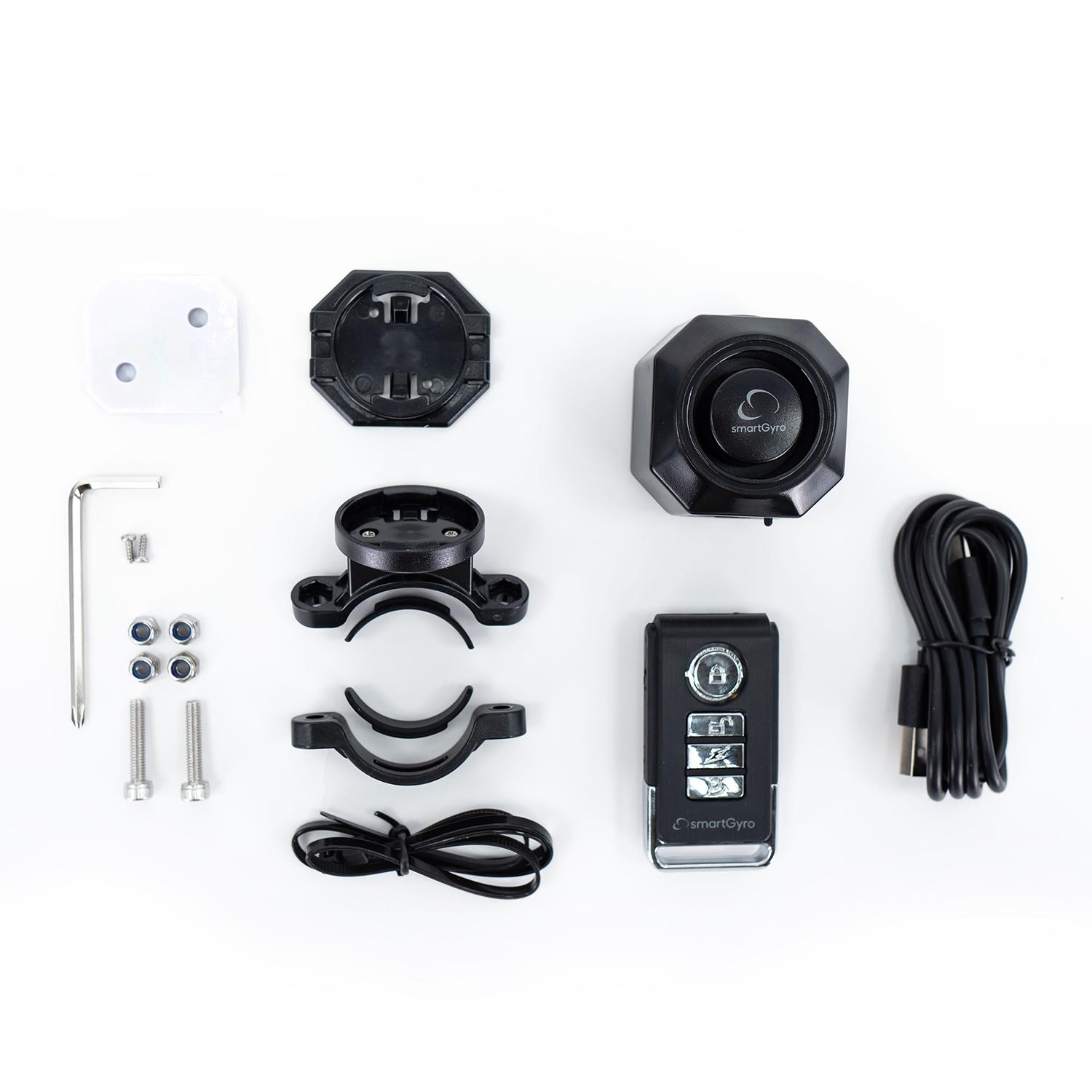 Różne czarne elementy urządzenia smartGyro, w tym pilot i części montażowe.