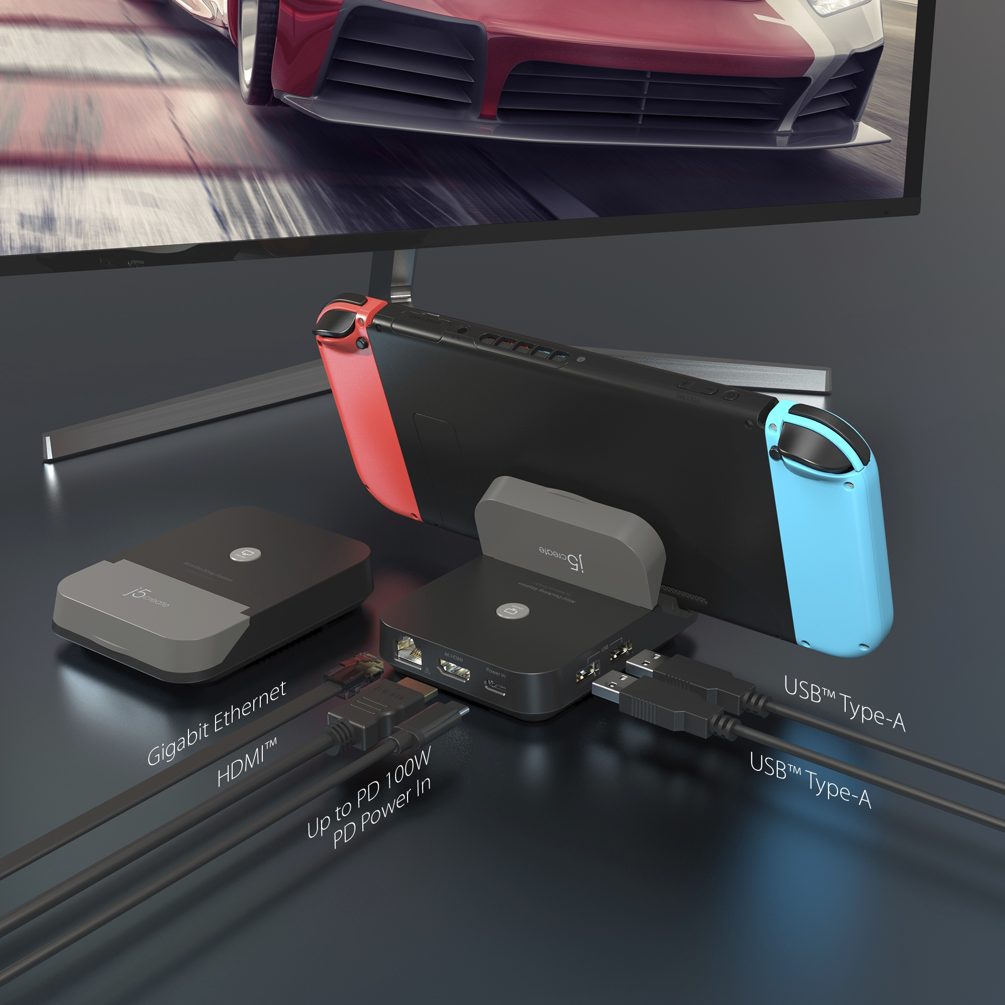 Eine schwarze Switch-Dockingstation mit Switch, Kabeln und einem Monitor mit einem roten Auto.