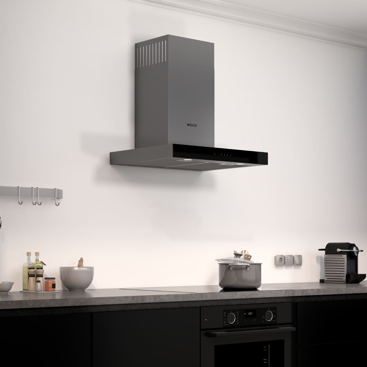 Kitchen scene with a grey range hood, black cabinets, and a pot on the stove. White wall background.