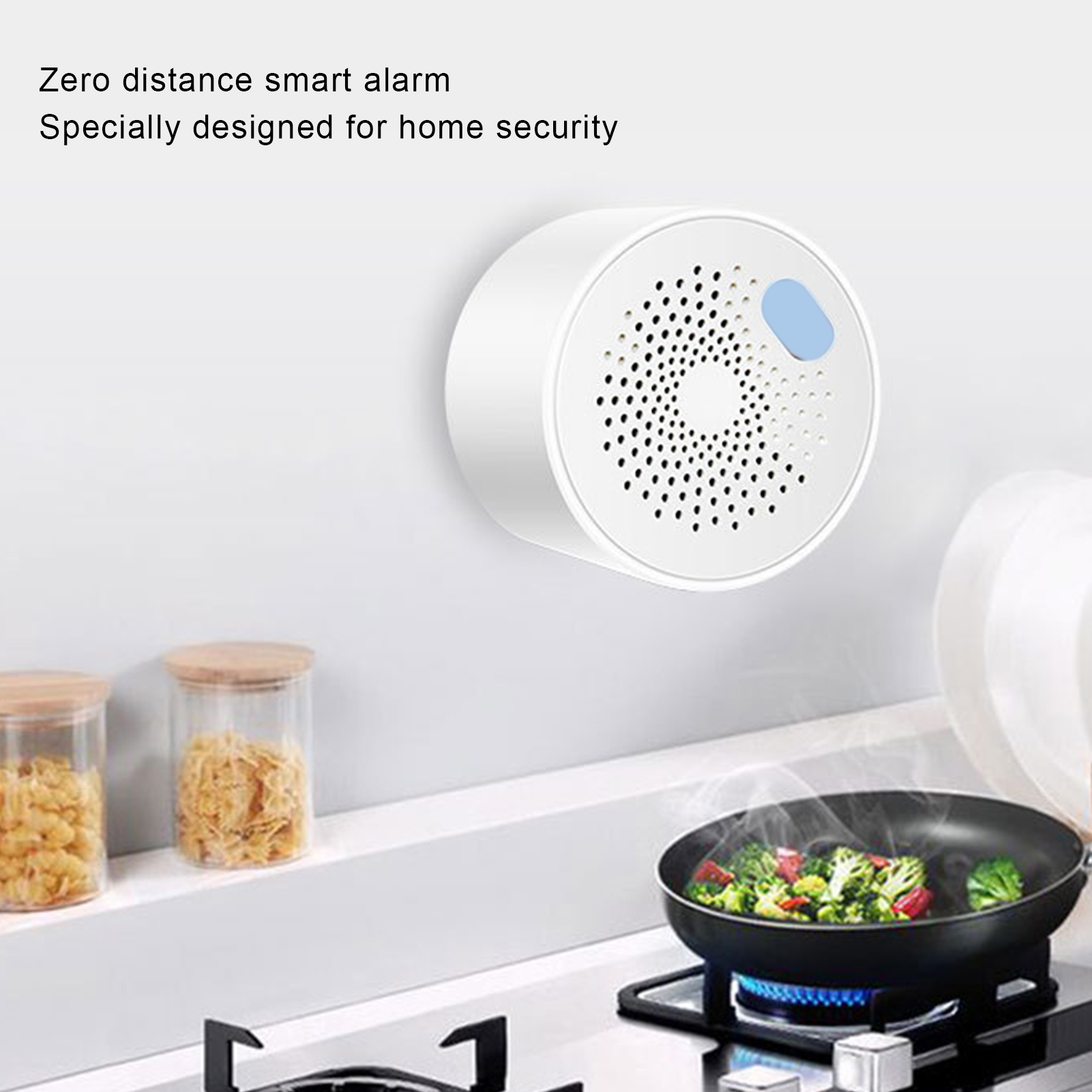 Weißer Smart-Alarm an einer Wand, Bratpfanne mit Essen auf einem Herd, Gläser.