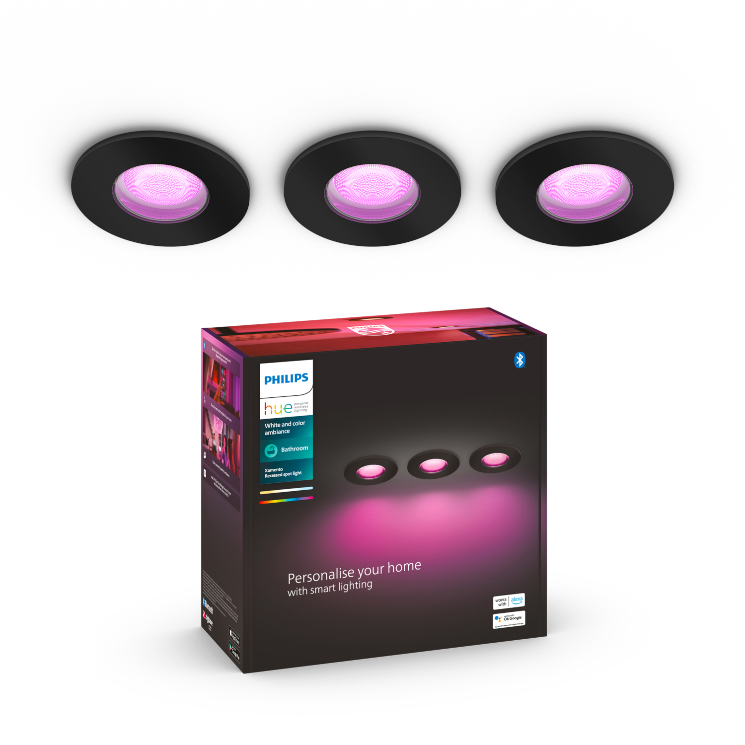 Tre faretti da incasso neri con luce rosa. Una scatola con il marchio Philips Hue è in primo piano.