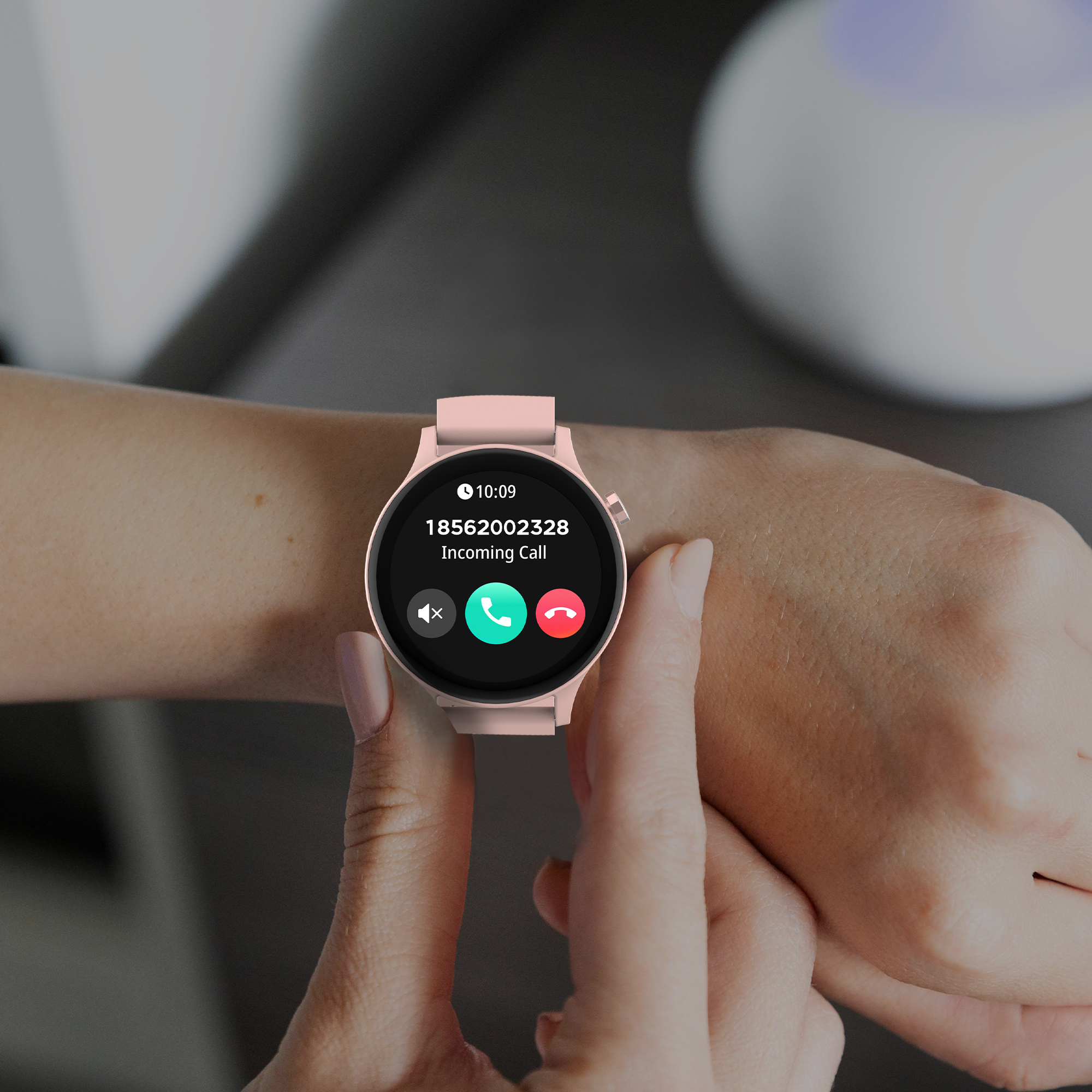 A woman's wrist with a pink smartwatch displaying an incoming call with buttons to answer or decline.