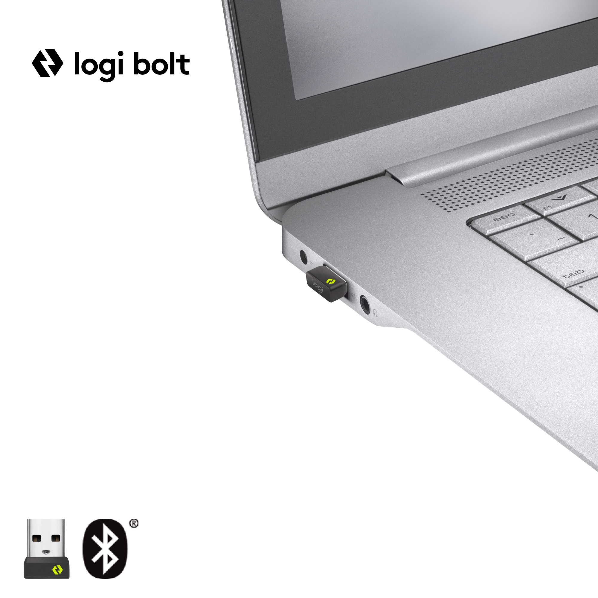 Un portátil plateado con un receptor USB conectado, con el logotipo de Logi Bolt. Se muestran un logotipo de Bluetooth y USB.