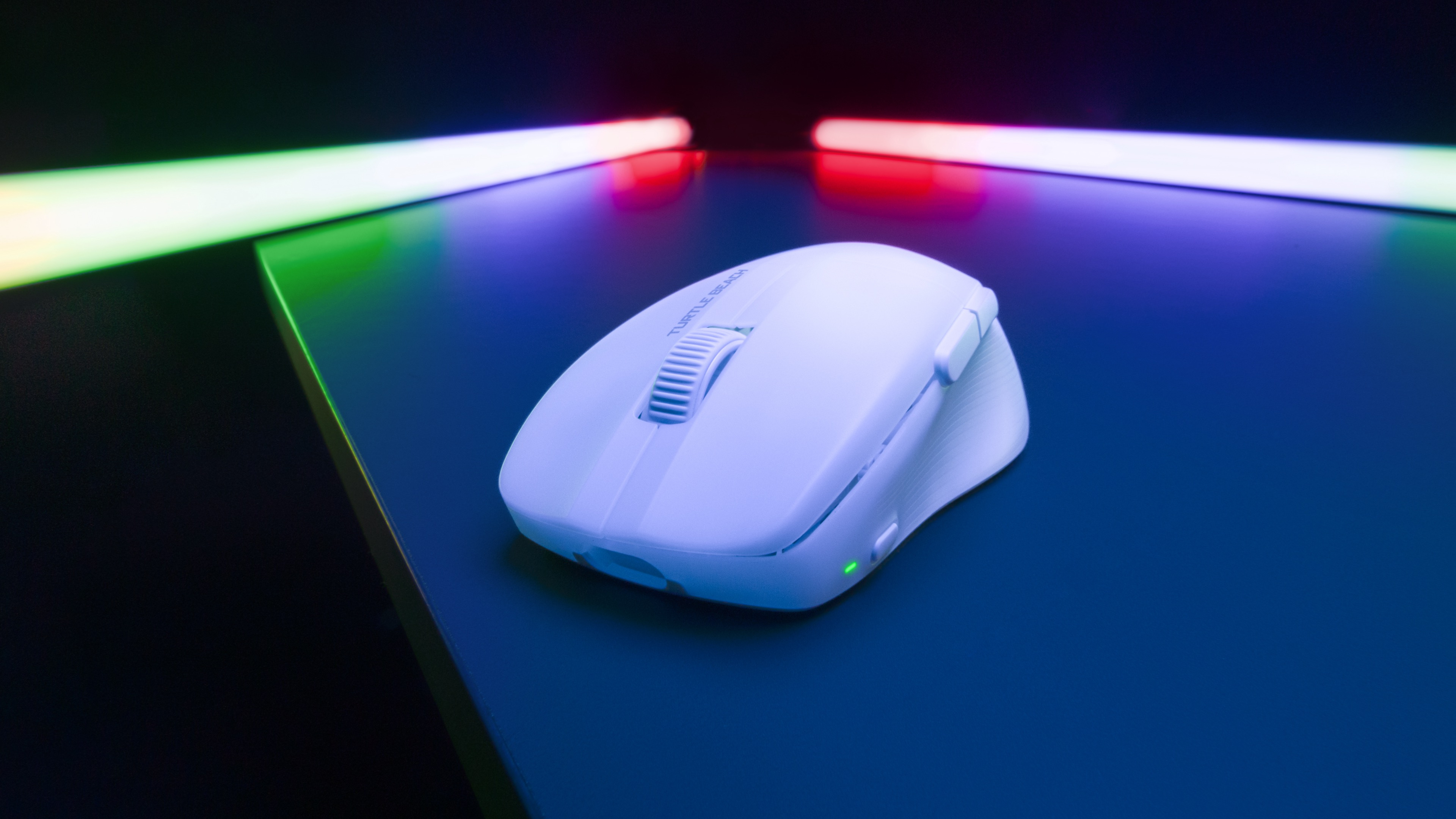 Eine weiße Computermaus auf einer blauen Oberfläche, beleuchtet von Neonlichtern, mit einem Scrollrad.