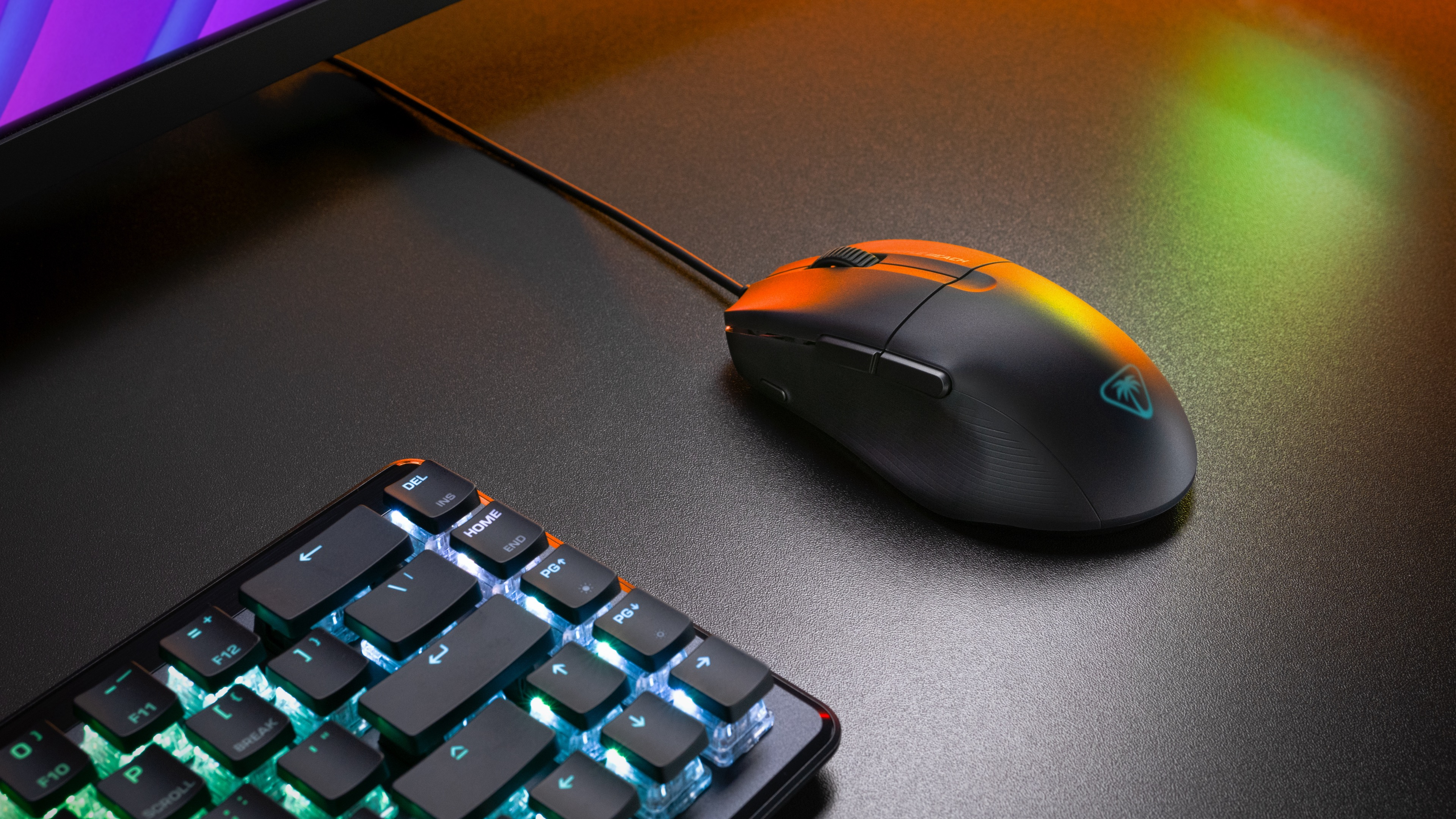 A black gaming mouse next to a keyboard. The scene is lit with orange and blue light.