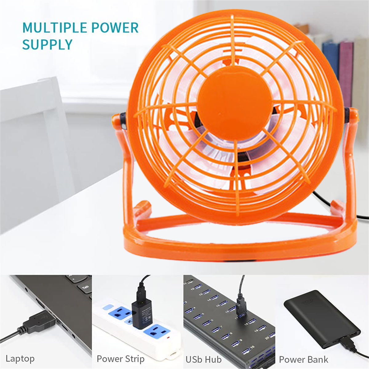 Oranger Ventilator, mehrere Stromversorgungsoptionen und Laptop. Weißer Tisch.