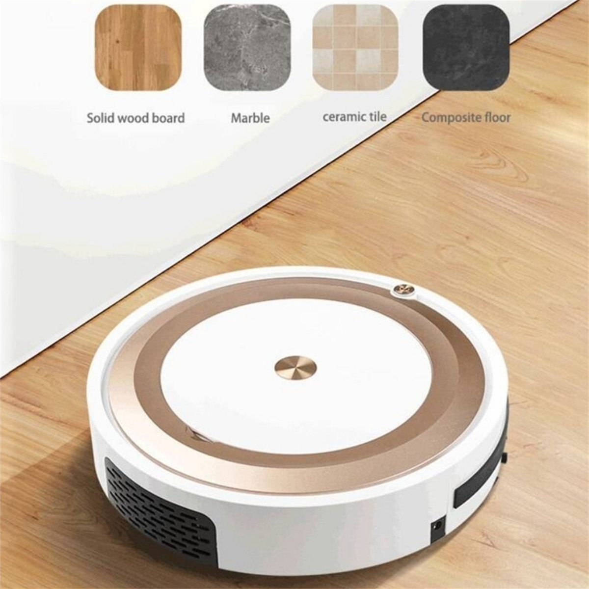 Ein weißer und goldener Roboterstaubsauger auf einem Holzboden mit Farbmustern darüber.
