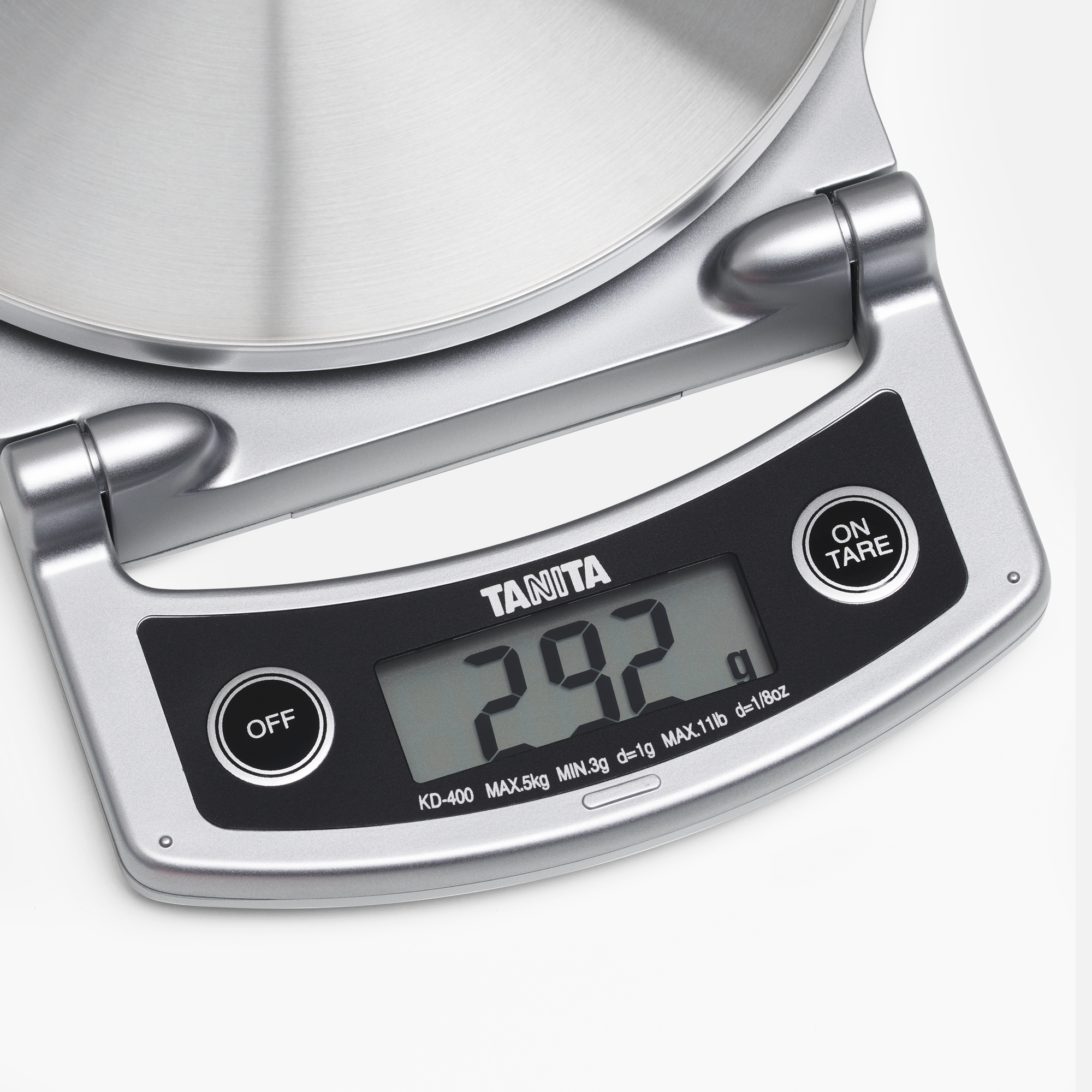 Silver digital kitchen scale displaying 292g on a black screen.