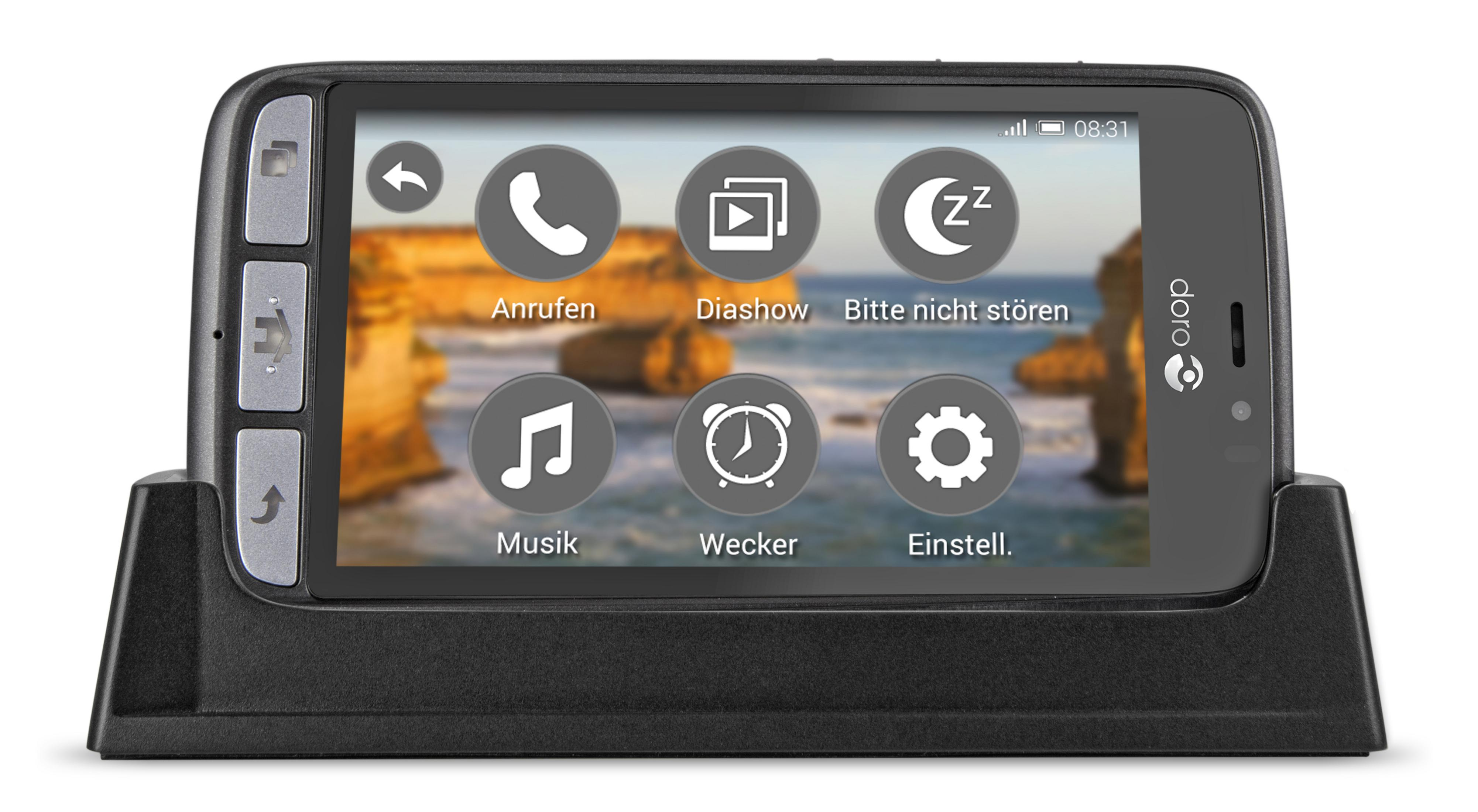 Schwarzes Smartphone mit großem Bildschirm in einer schwarzen Ladestation.