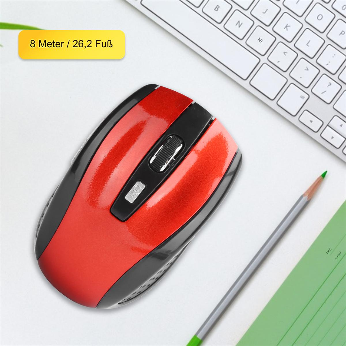 Rote und schwarze kabellose Maus. Eine weiße Tastatur und ein Bleistift sind im Hintergrund sichtbar.