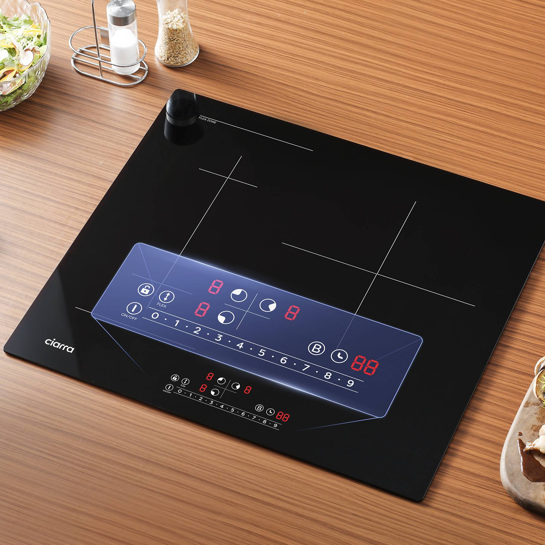 Black induction hob with digital display and controls, resting on wooden surface.